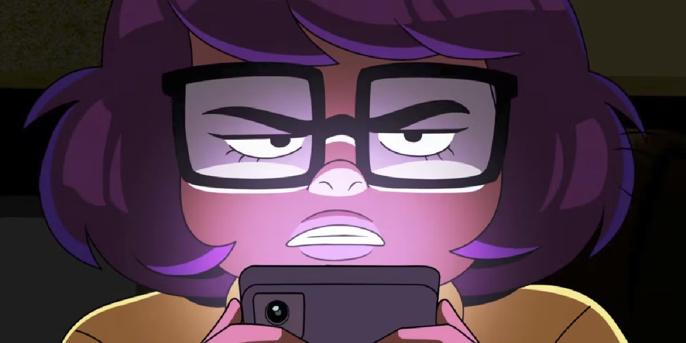 Velma holding a phone and looking angry in the Max series