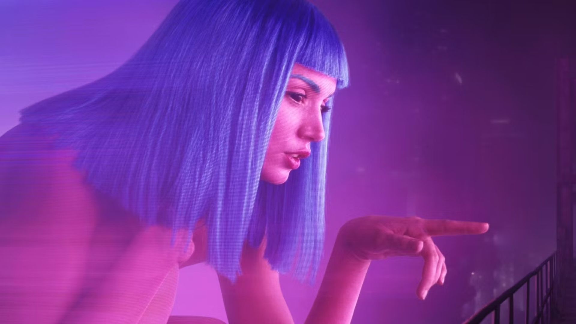 Ana de Armas in a blue wig pointing in Blade Runner 2049