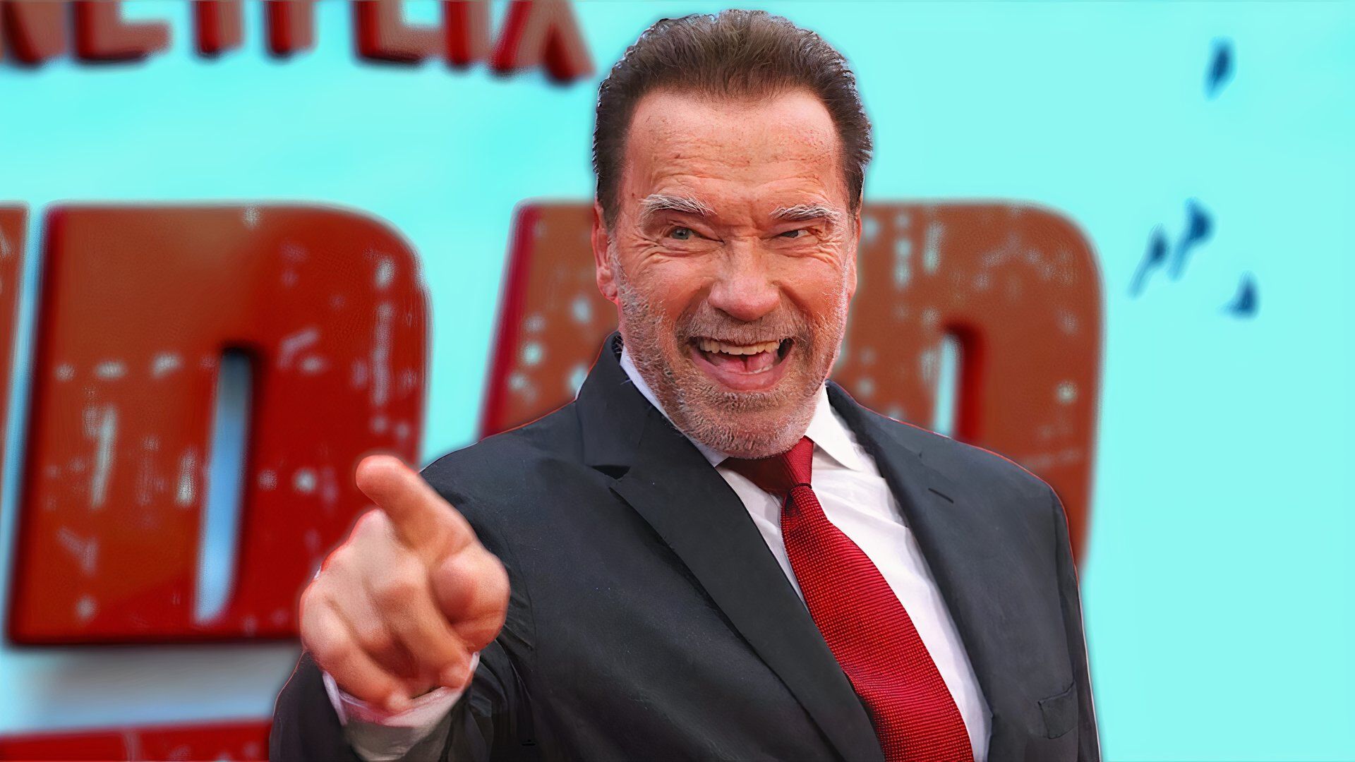 Arnold Schwarzenegger points his finger and laughs