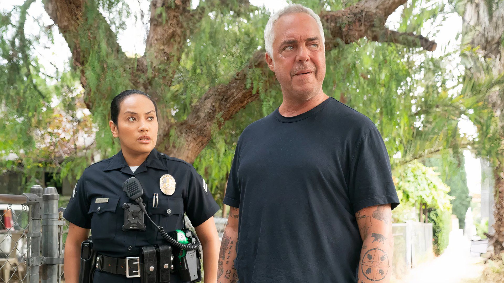 Reyna and Harry stand by a tree in Bosch: Legacy