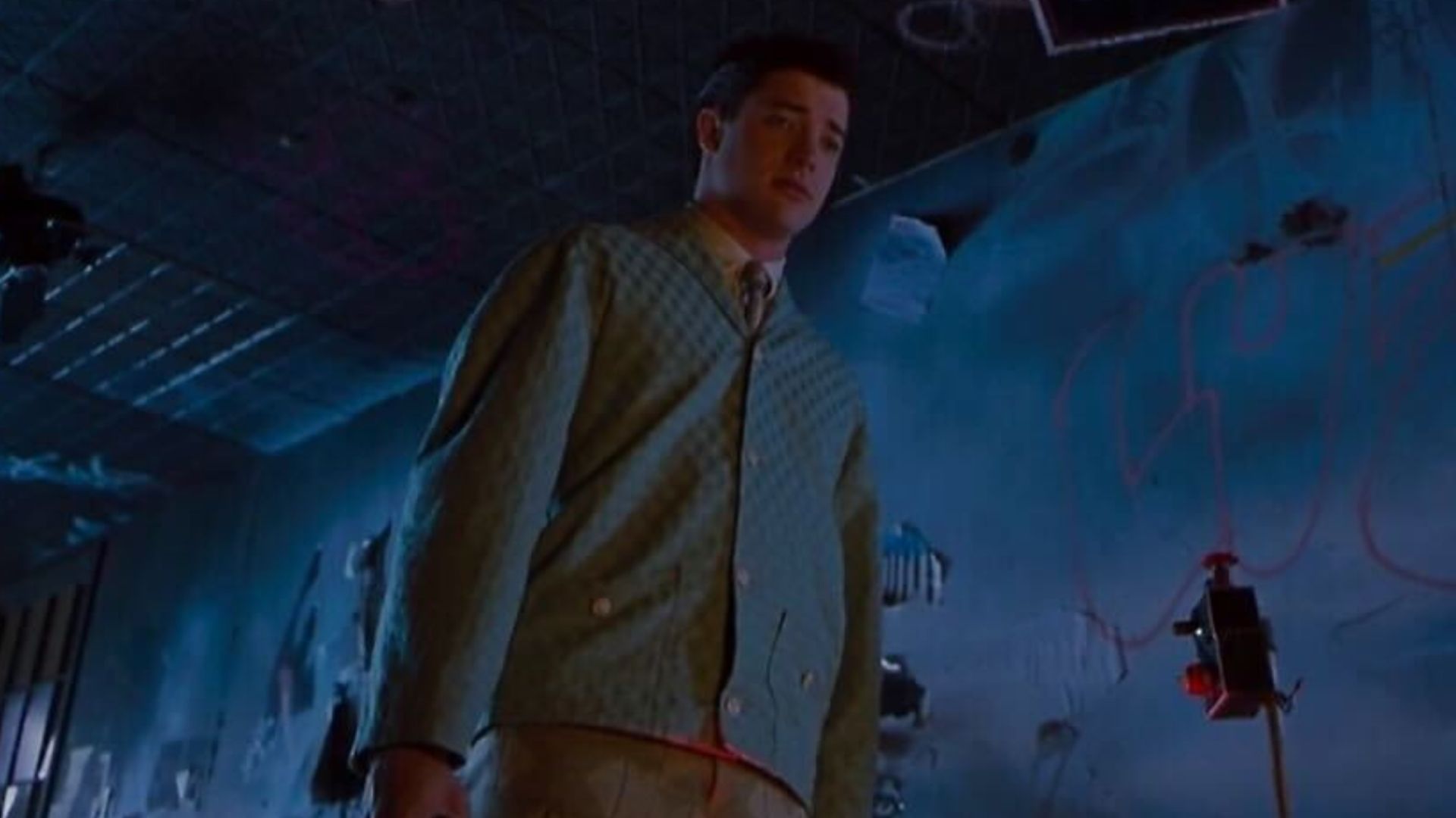 Brendan Fraser in a dark room with graffiti on the walls in Blast From the Past