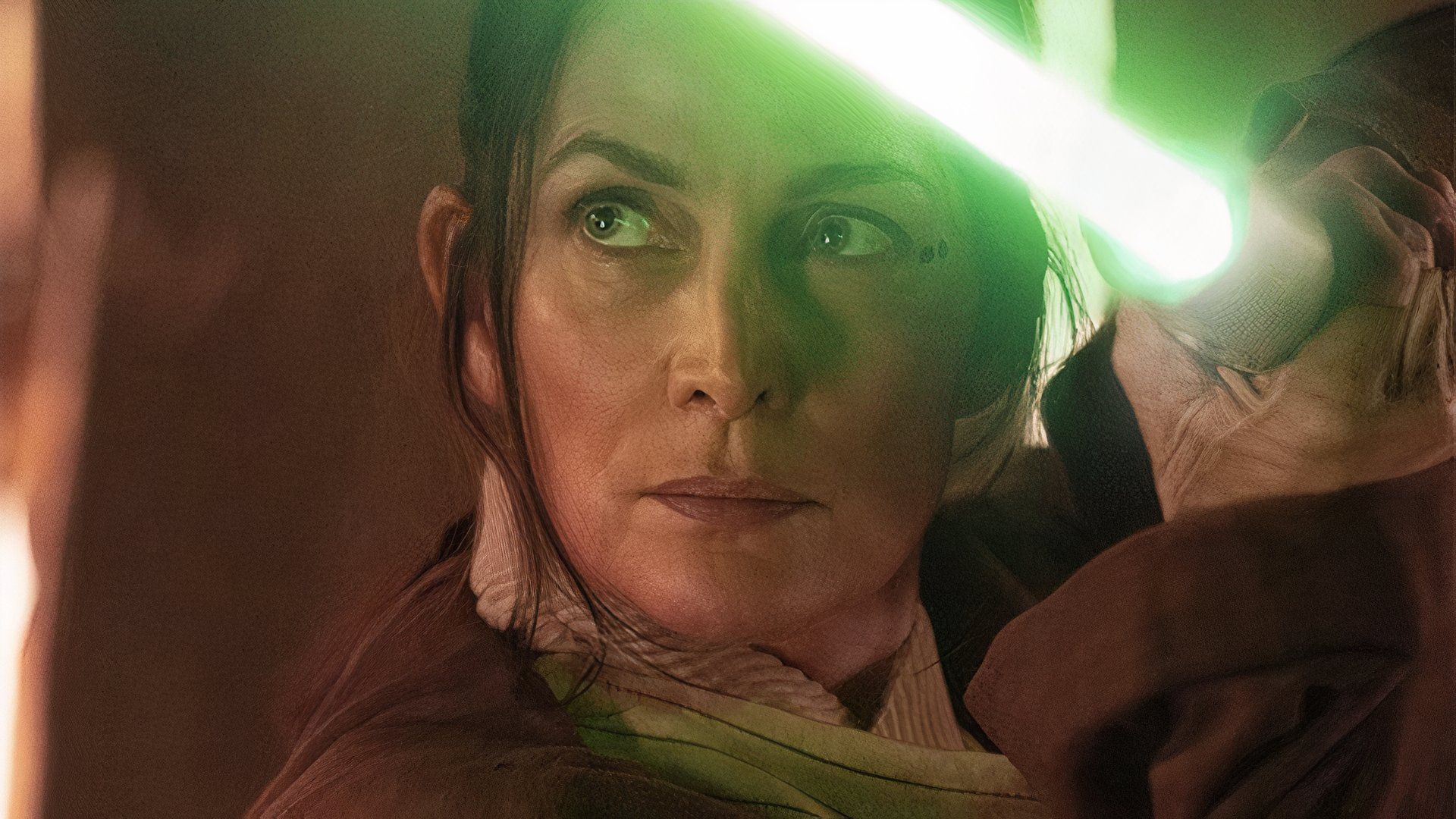 Carrie-Anne Moss as Indara in Star Wars: The Acolyte wielding a green lightsaber