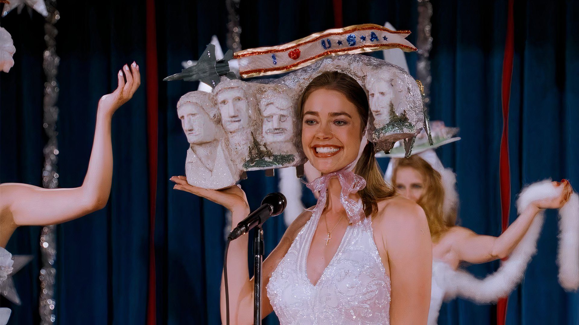 Denise Richards wearing a Mount Rushmore hat in Drop Dead Gorgeous