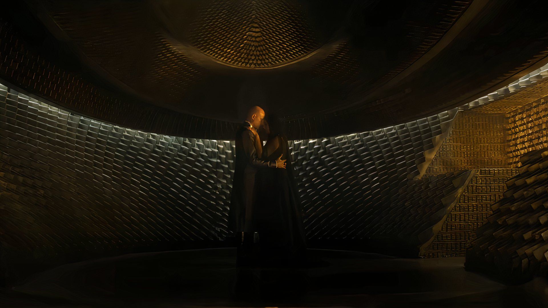 Two characters embrace in a dark room in Dune: Prophecy on Max