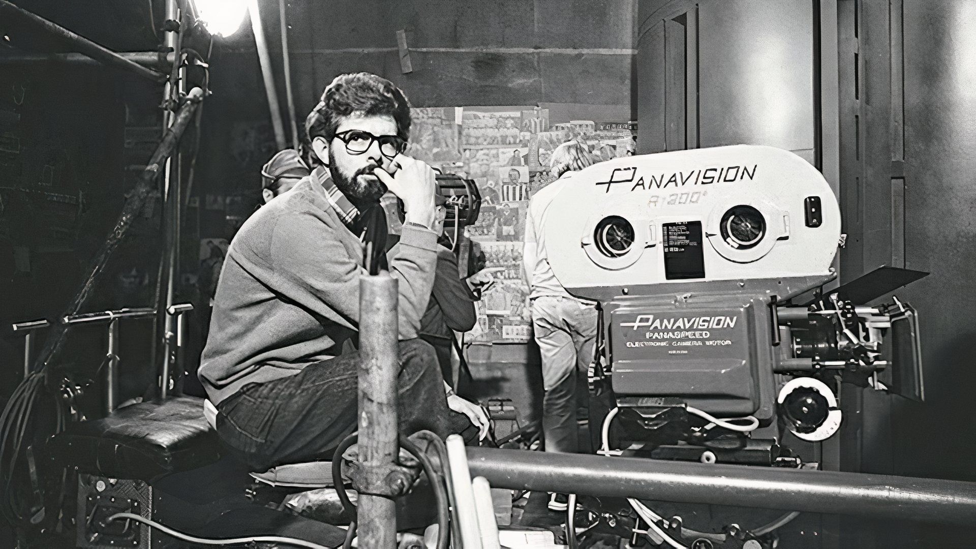 George Lucas sits behind a Panavision camera while filming a scene from Star Wars: A New Hope