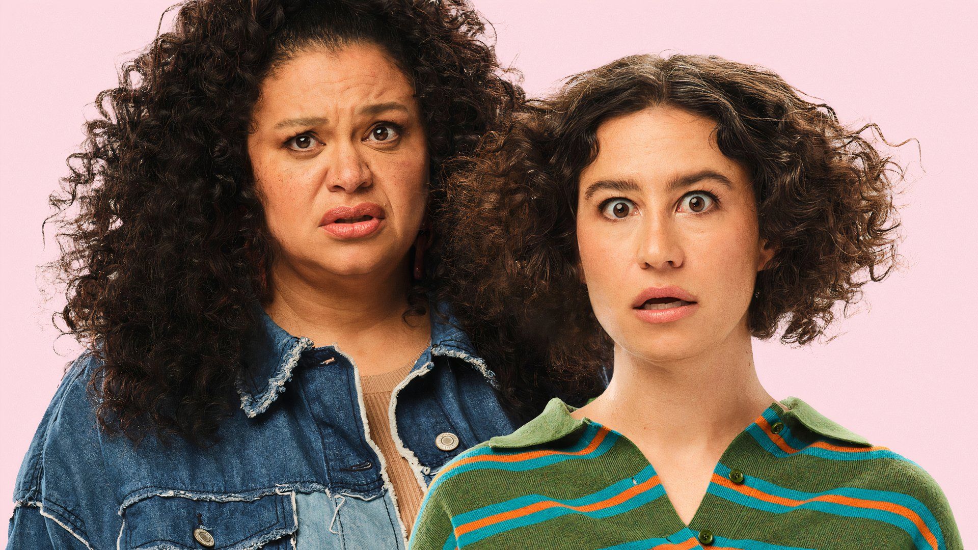Ilana Glazer and Michelle Buteau looking directly toward the audience in Babes