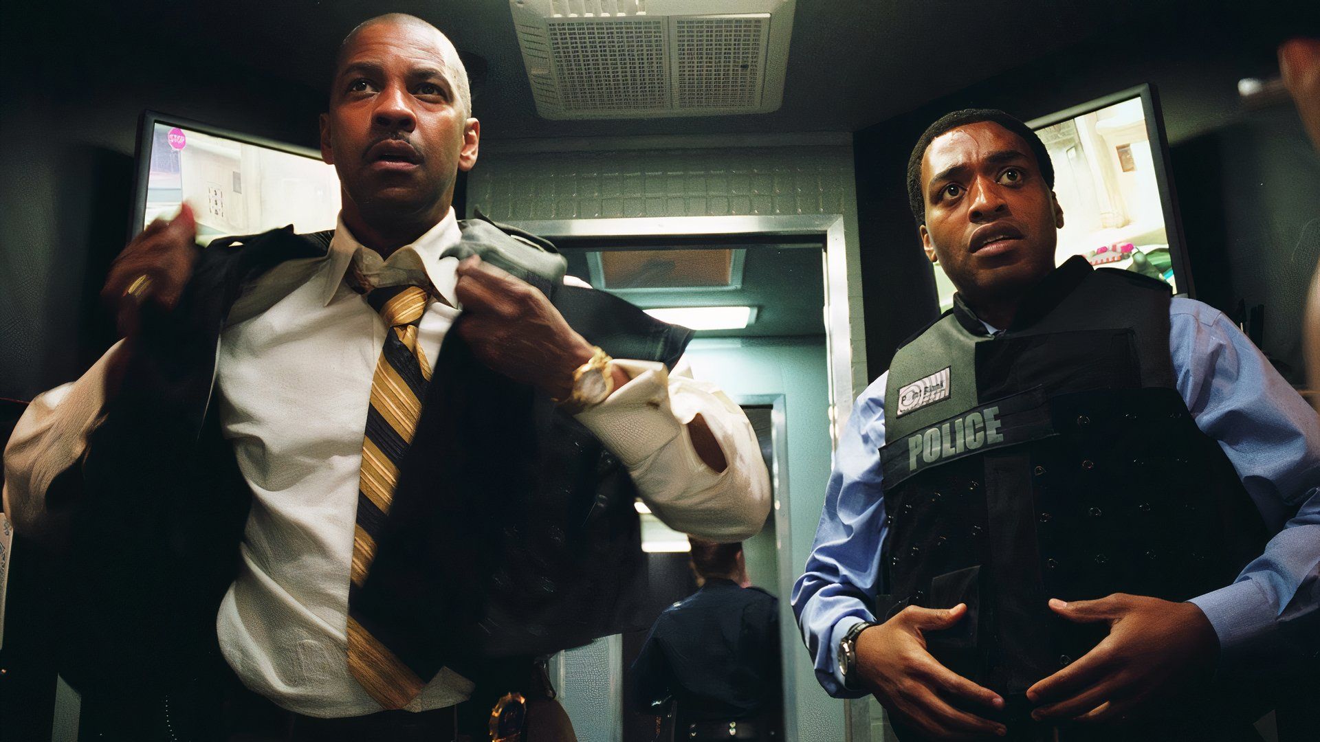 Keith and Bill don police vests in Inside Man