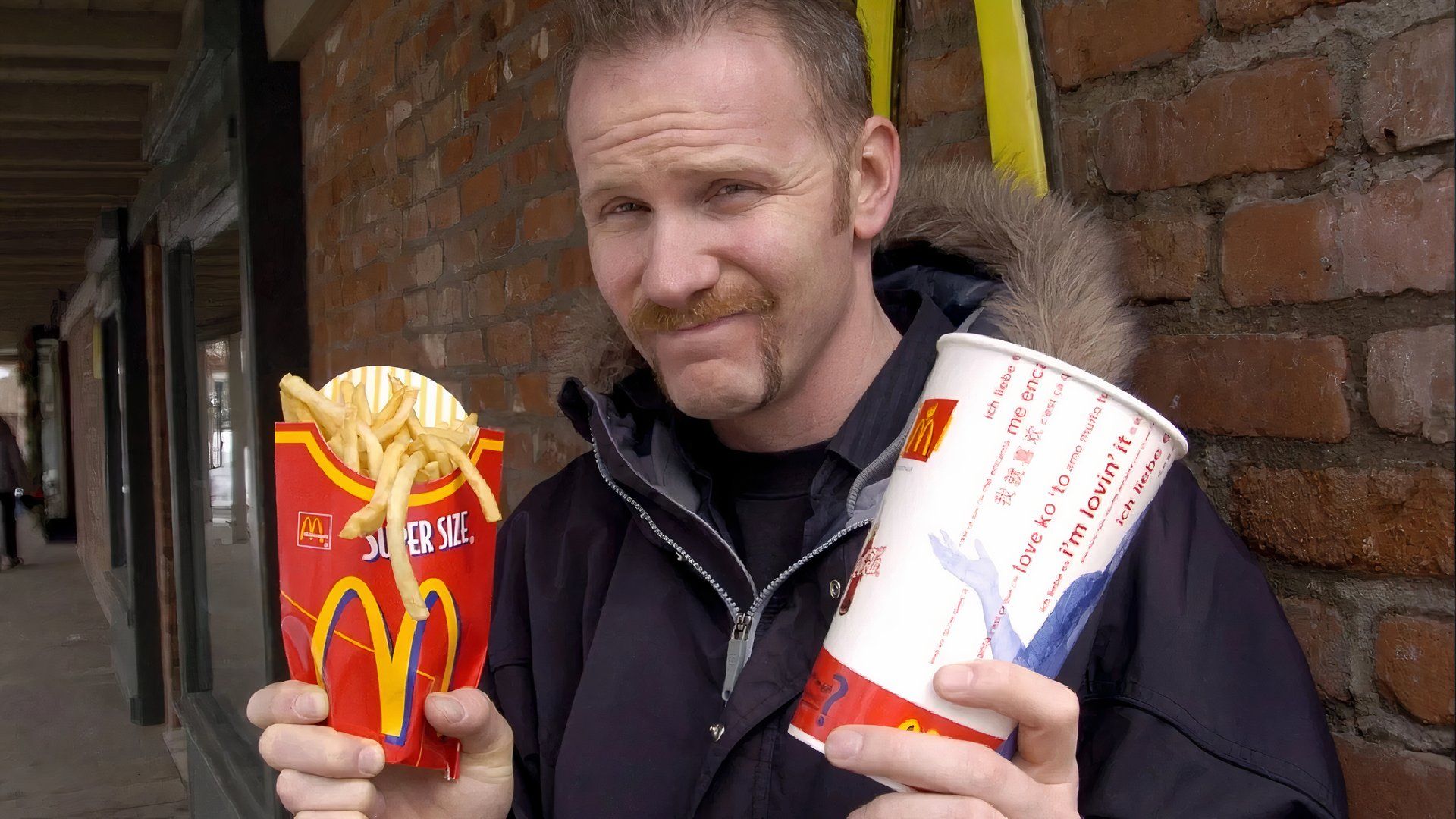 Morgan Spurlock holding fries and mcdonalds coke