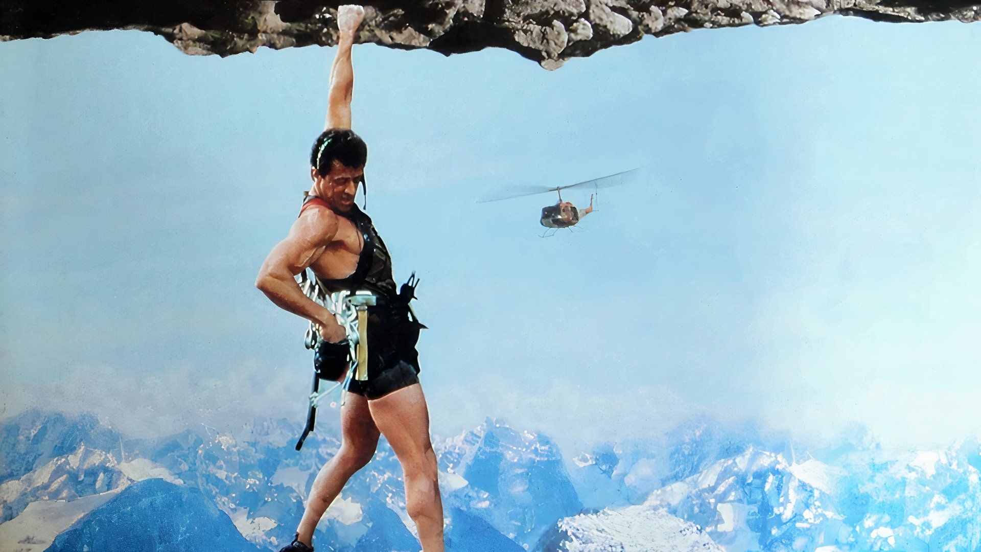 Sylvester Stallone hanging by a rock in Cliffhanger