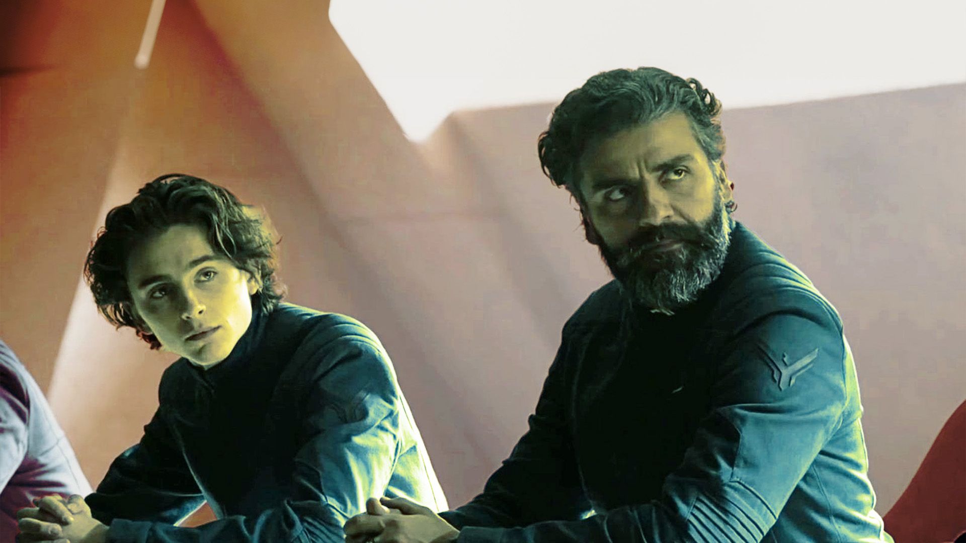An edited image of Oscar Isaac as Leto Atreides and Timothee Chalamet as Paul Atreides at a meeting in Dune