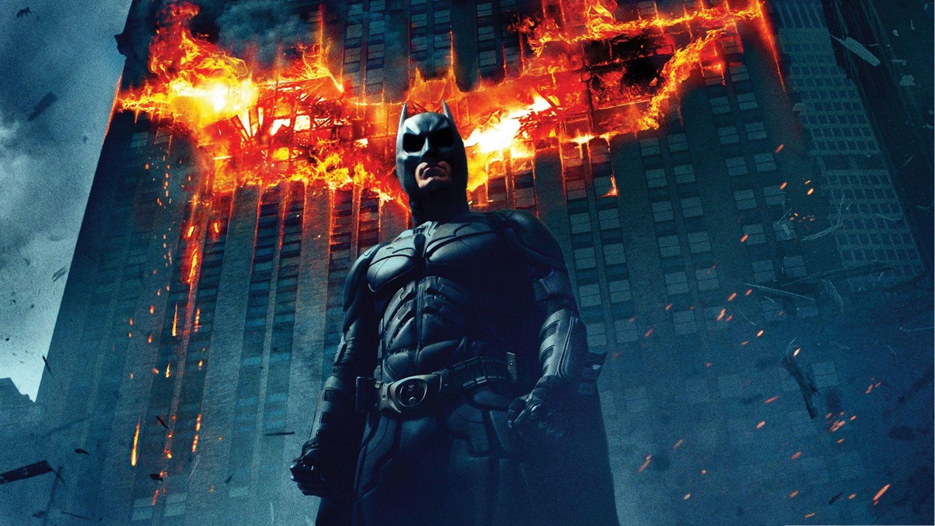 Batman in front of a flaming symbol.