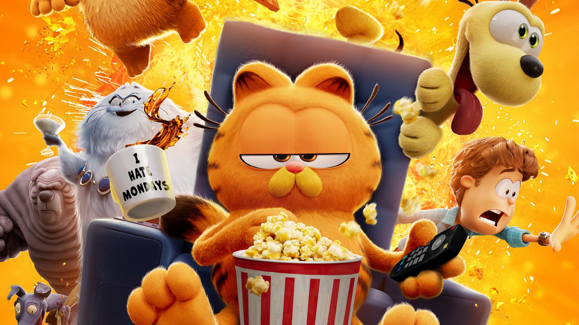 The Garfield Movie with Chris Pratt as the cat eating popcorn in a chair with a remote control while things explode behind him