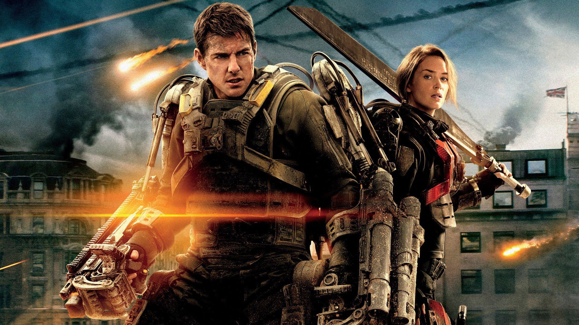 Tom Cruise and Emily Blunt in futuristic exoskeleton with a destroyed city in the backdrop, Edge of Tomorrow, 2014