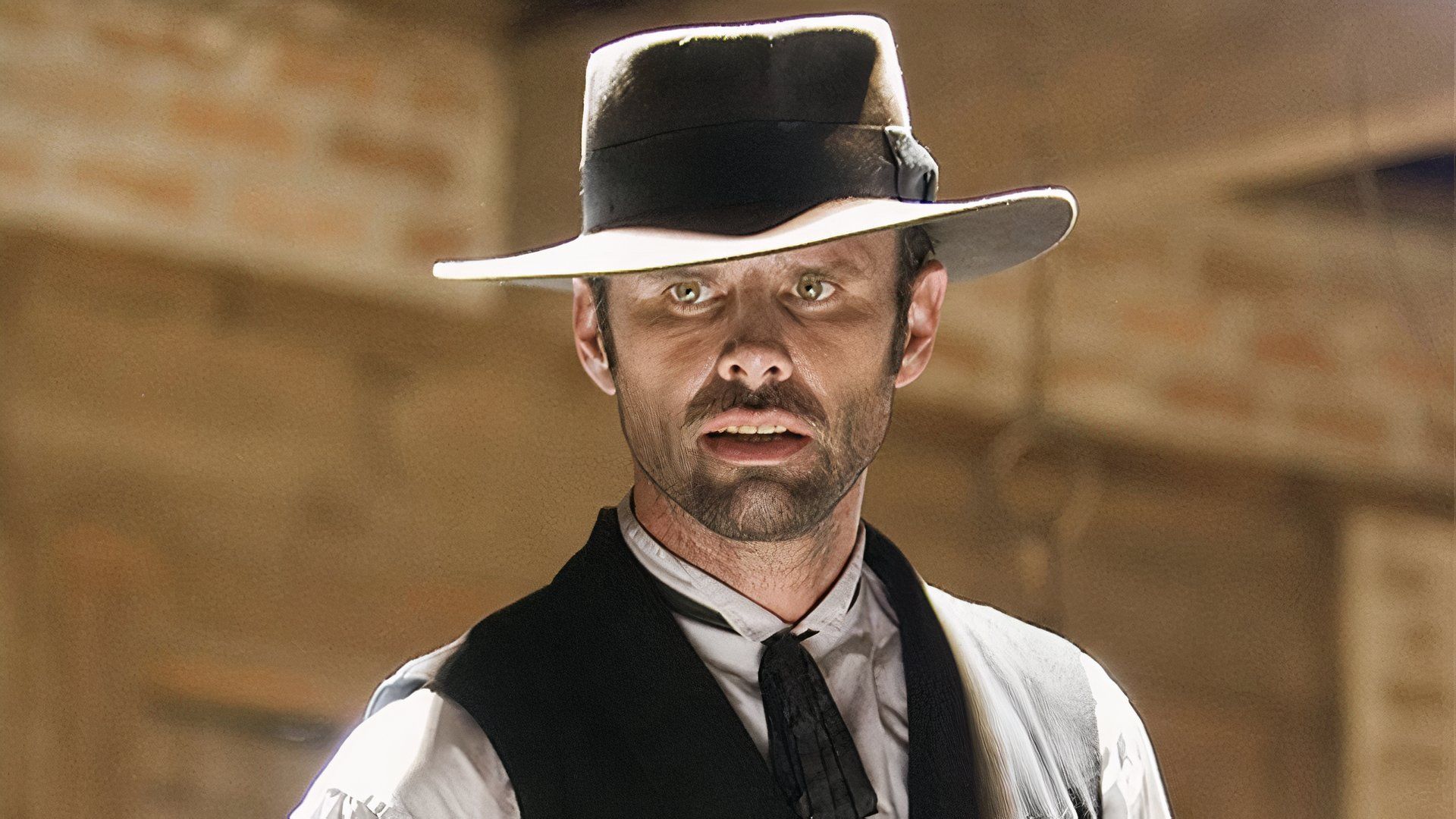 Billy wears a vest and tie in Django Unchained