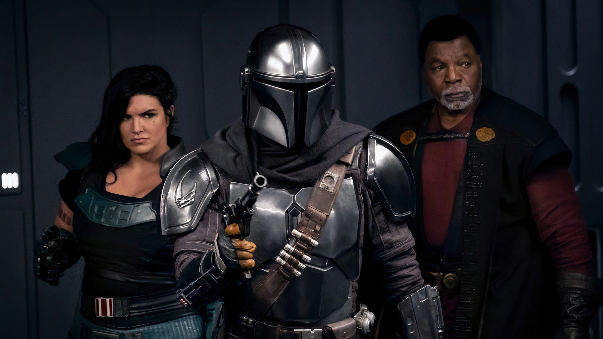 Gina Carano in The Mandalorian with Din Djarin in front of her holding a blaster