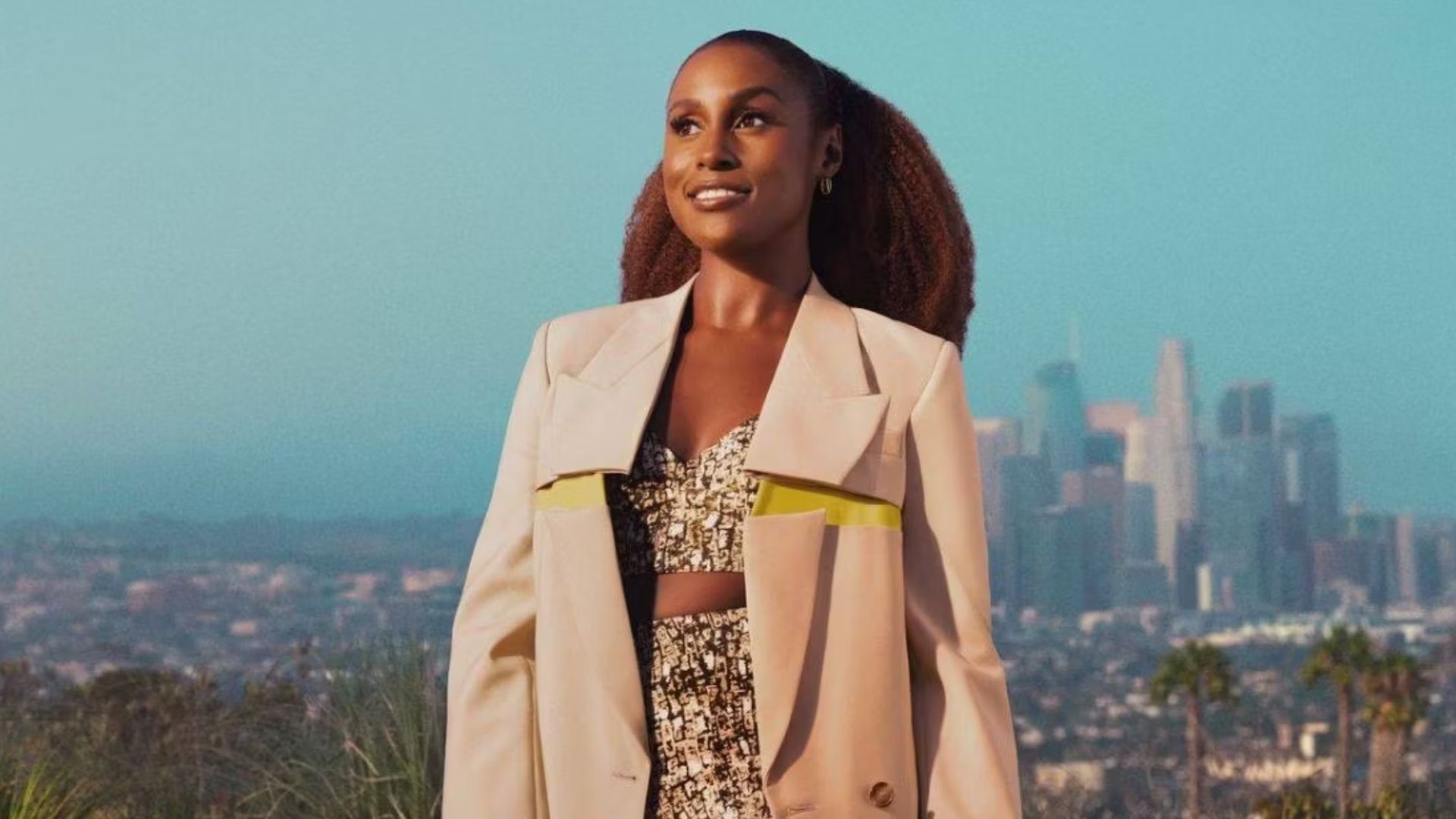 Issa Rae standing triumphantly in front of the LA Skyline, Insecure