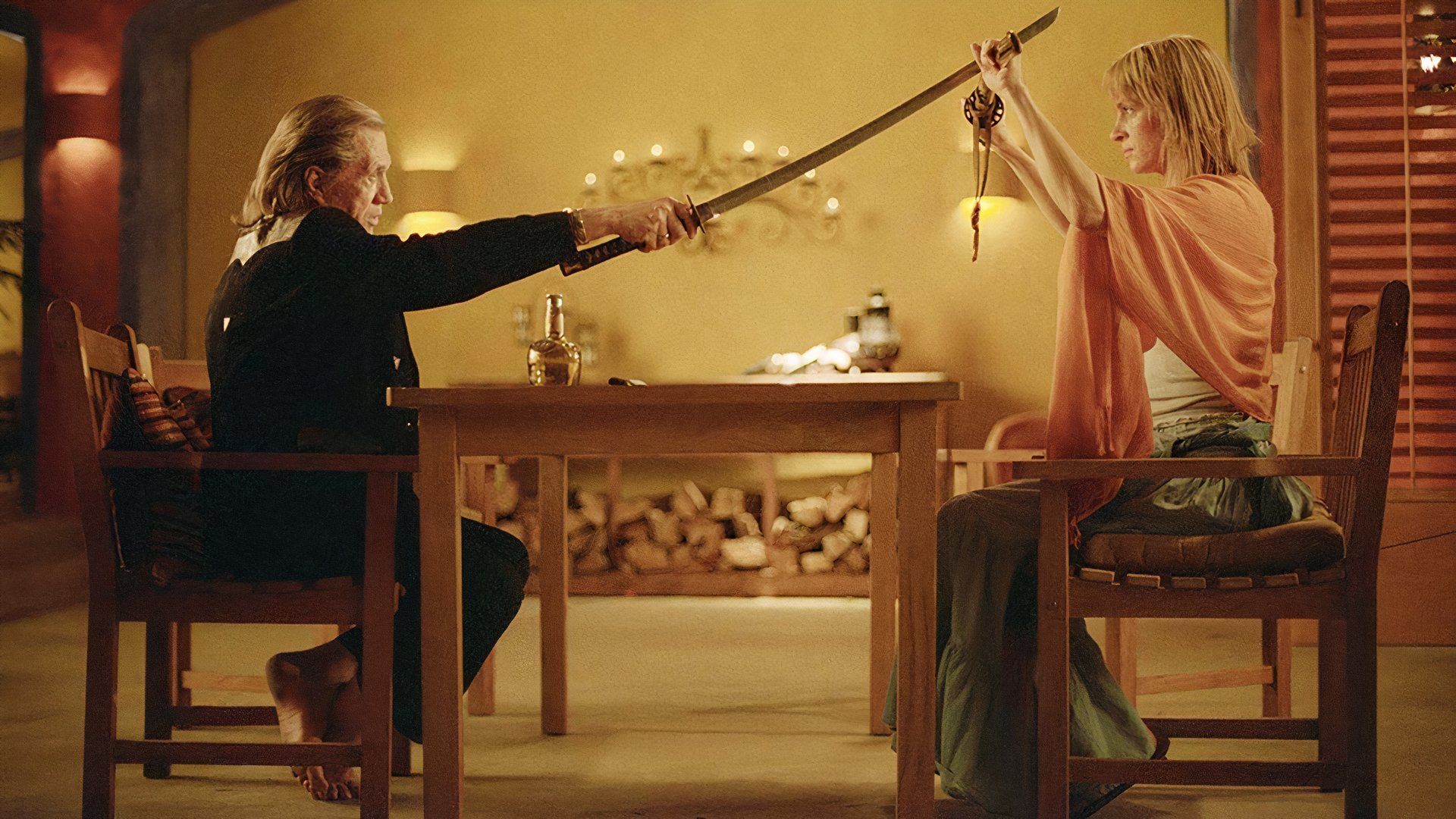 Bill and Beatrix sword fight at a table in Kill Bill
