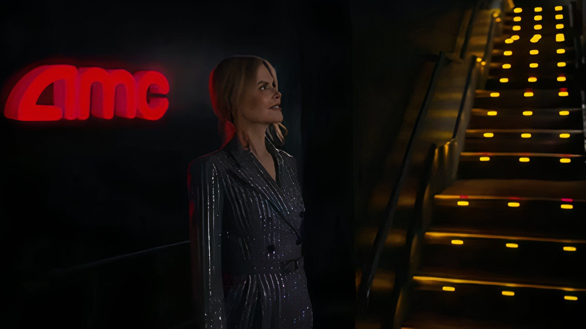 Nicole Kidman in her AMC ad in a movie theaters wearing a suit jacket