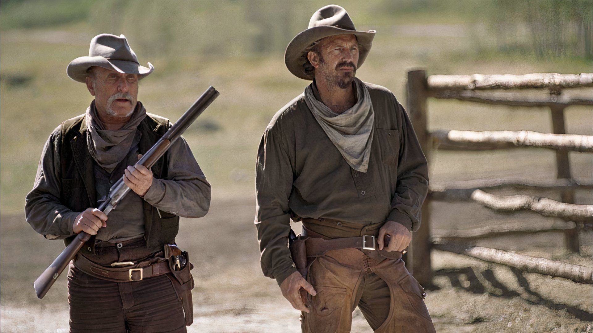 Boss and Charley stand together in Open Range