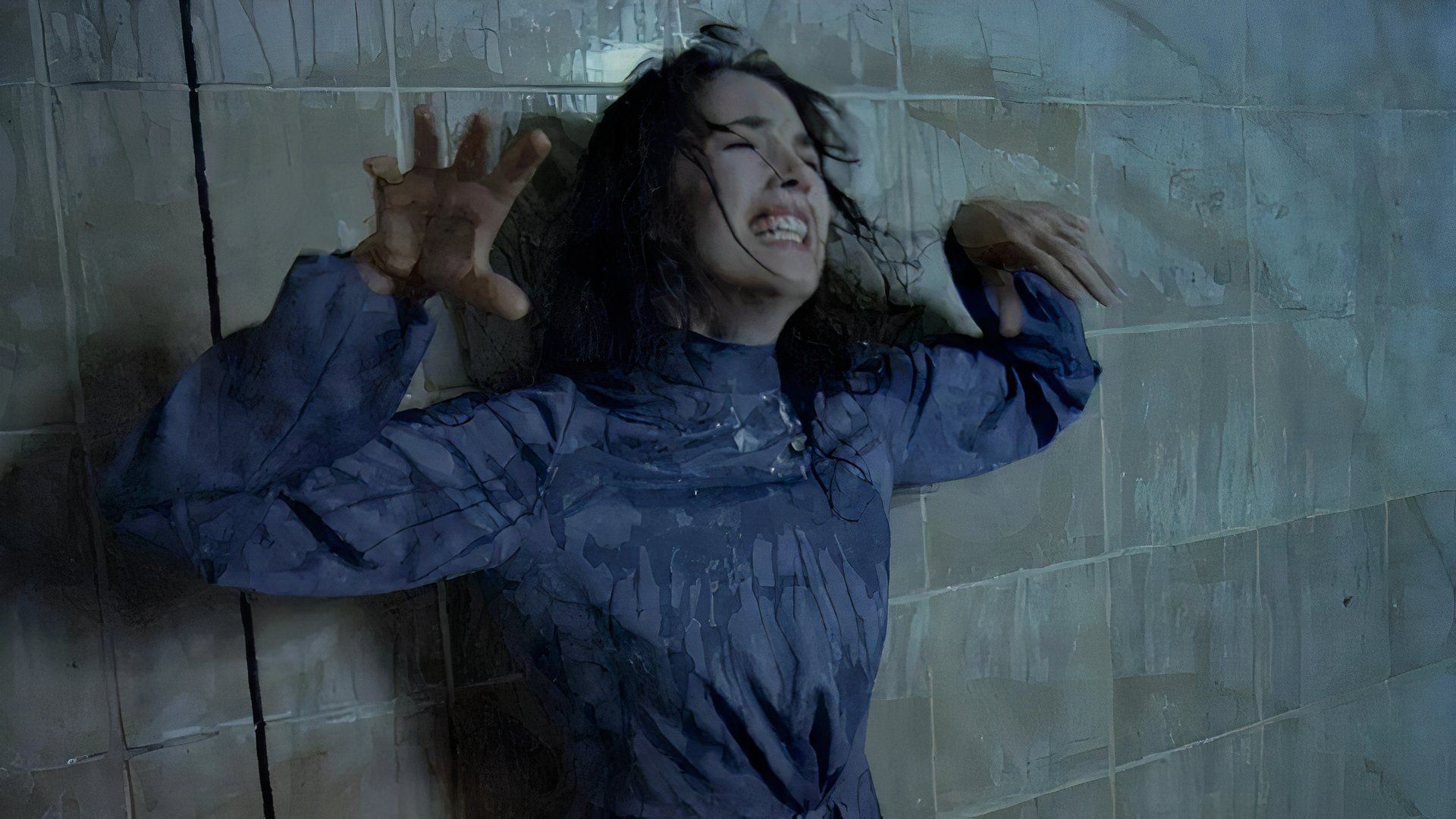 Isabelle Adjani looks extremely distressed and drowns in a strange liquid in a scene from the movie Possession.