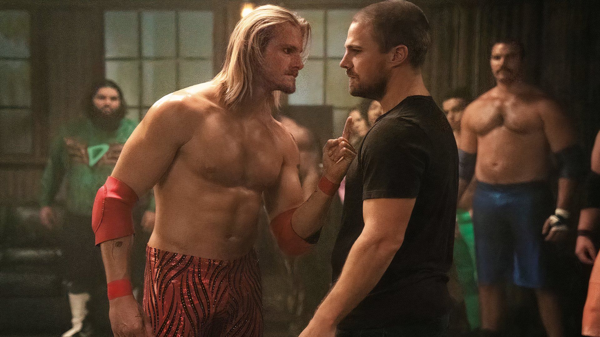 Stephen Amell and Alexander Ludwig in a room wearing wrestling gear in Heels