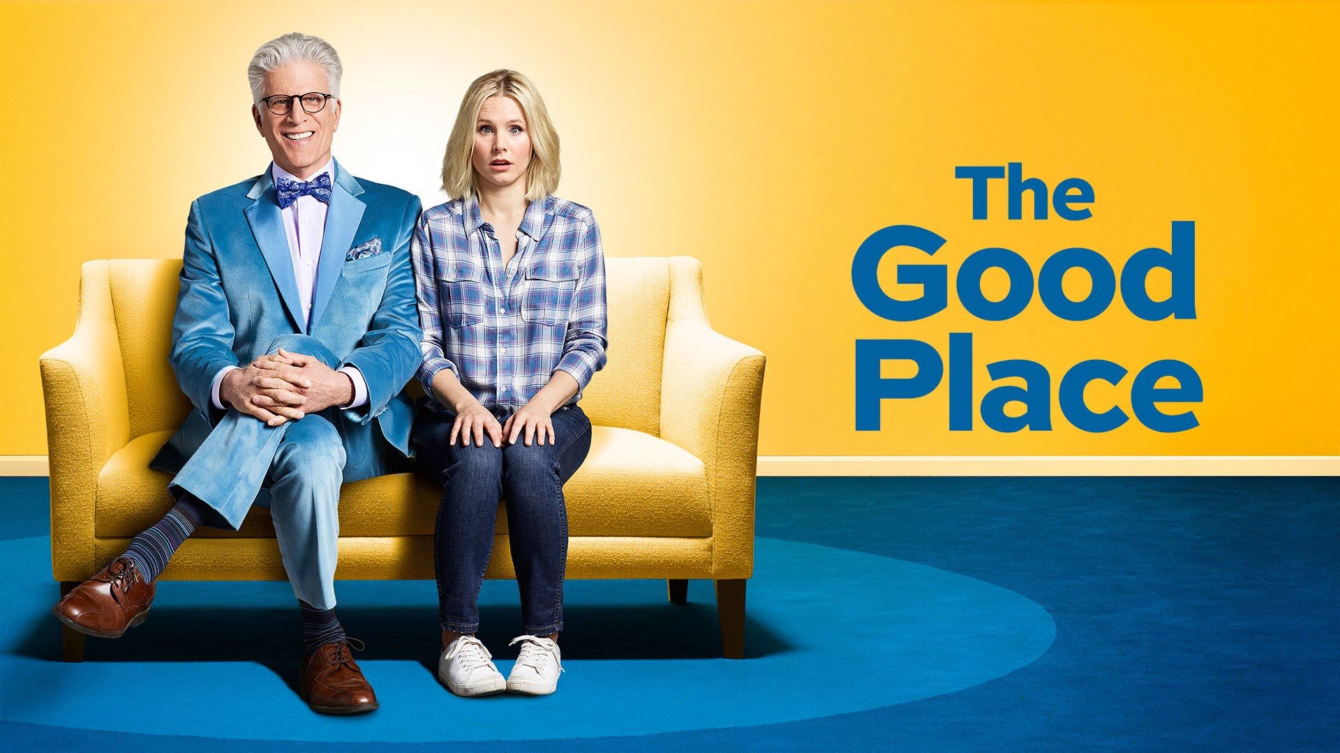 Ted Danson and Kristen bell sitting in a bright yellow room with a deep blue floor, The Good Place