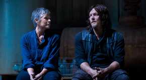 Carol and Daryl from The Walking Dead in the dark sitting together.