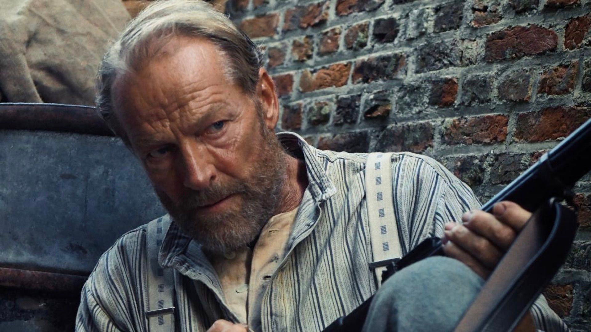 Iain Glen as Leonard in The Last Front holding a gun