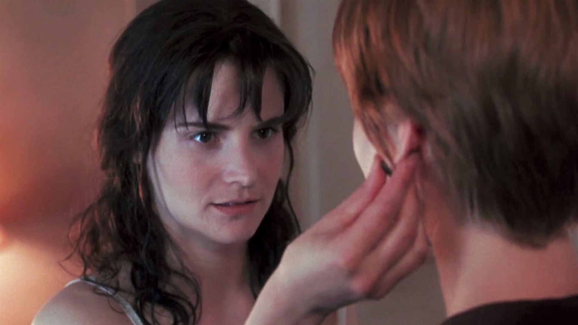 Jennifer Jason Leigh touching someone's earlobe as Hedy in Single White Female