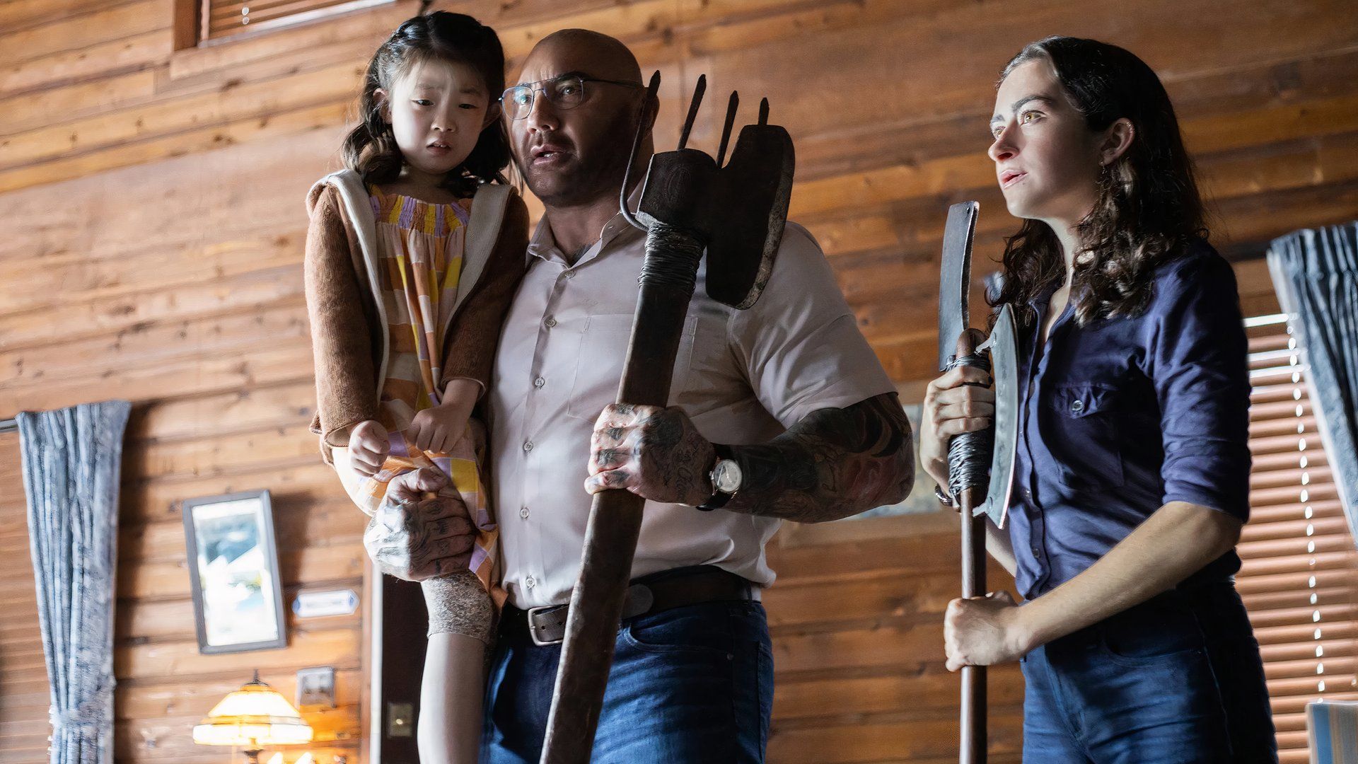 Leonard holds a pitchfork in Knock at the Cabin