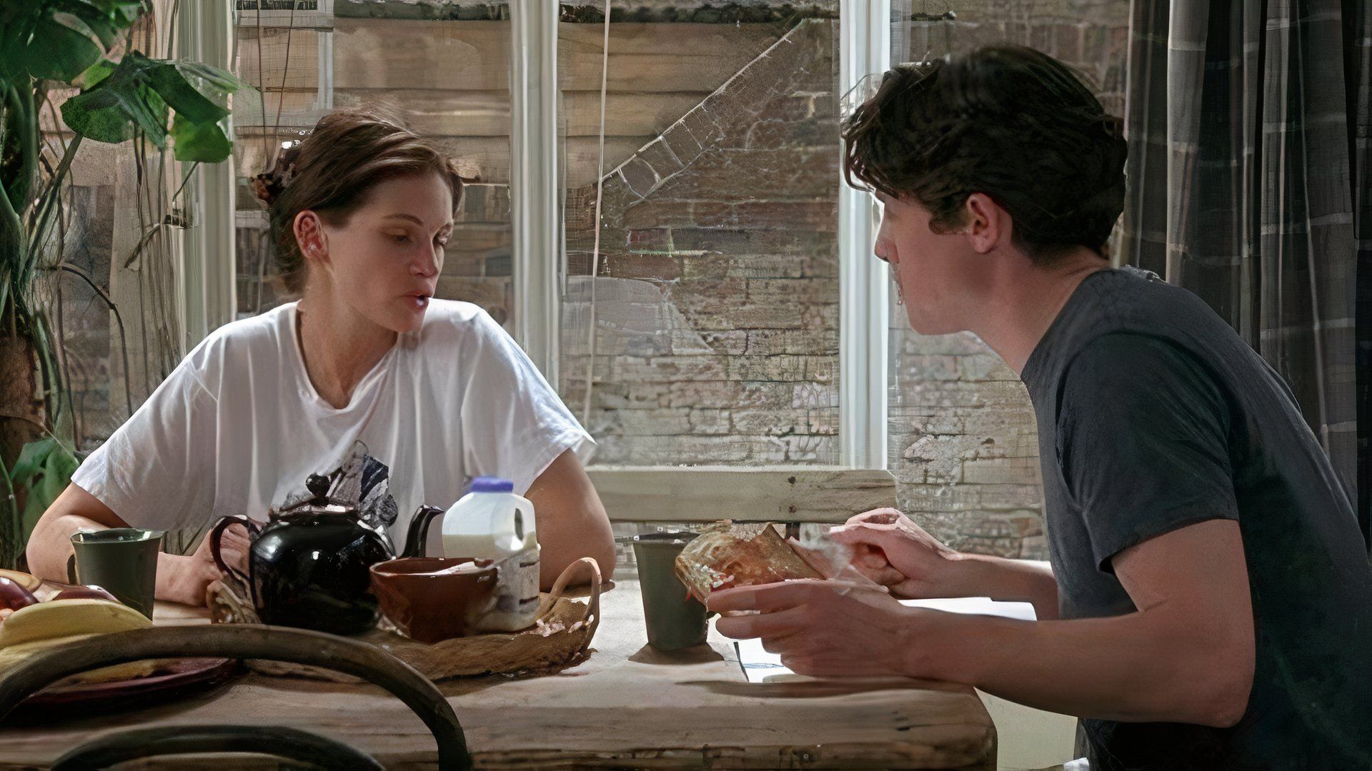 Hugh Grant and Julia Roberts sitting at a breakfast table eating