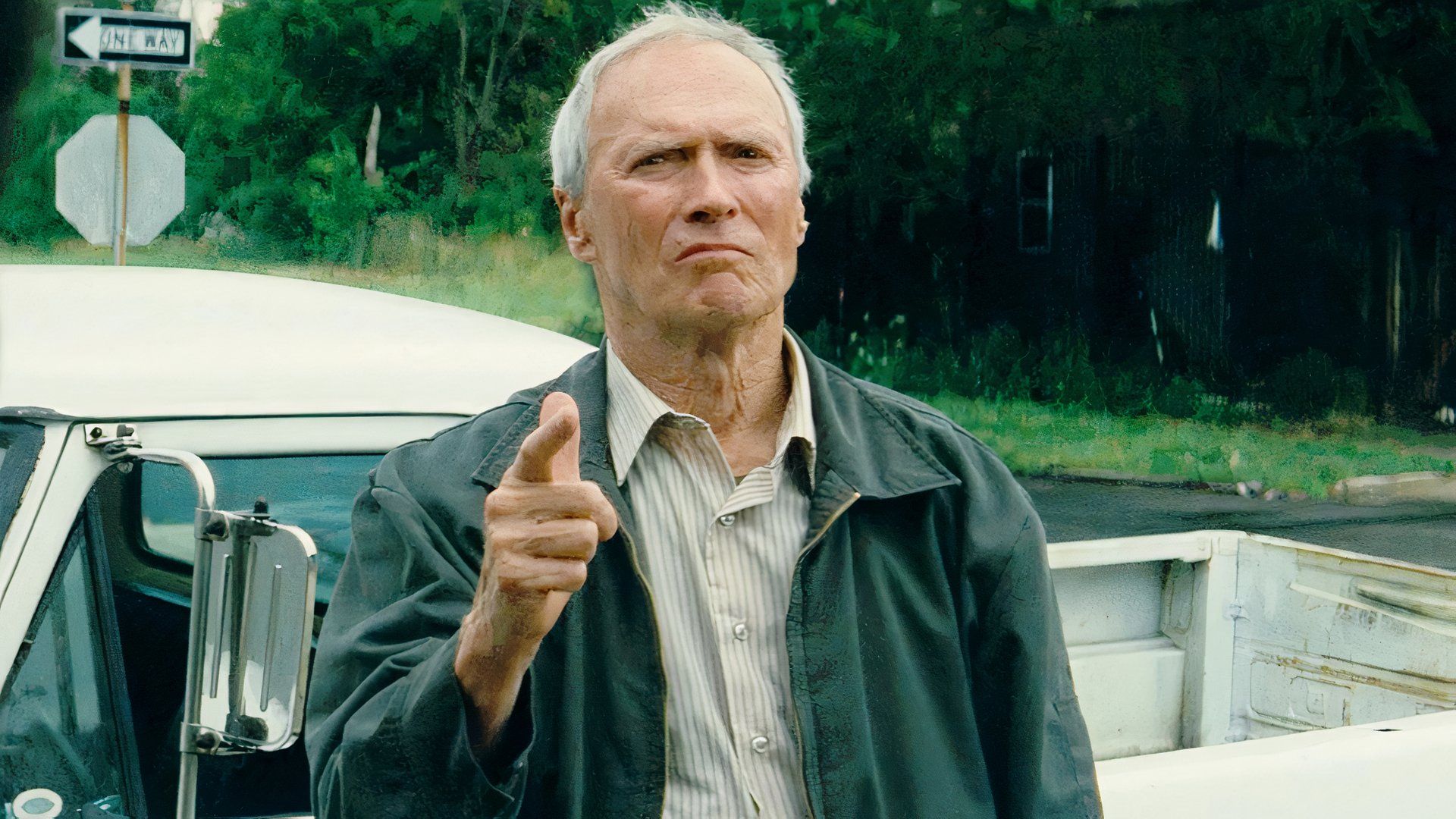 Clint Eastwood as Walt Kowalski in Gran Torino pointing at someone off-screen