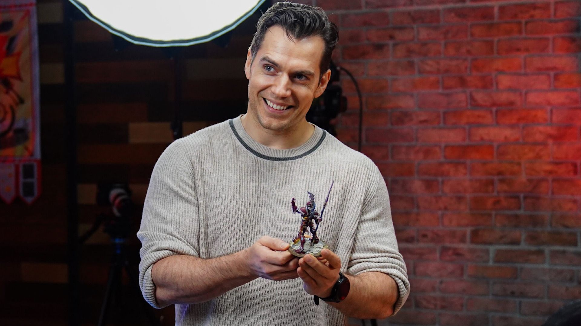 Henry Cavill holding a Warhammer 40K model