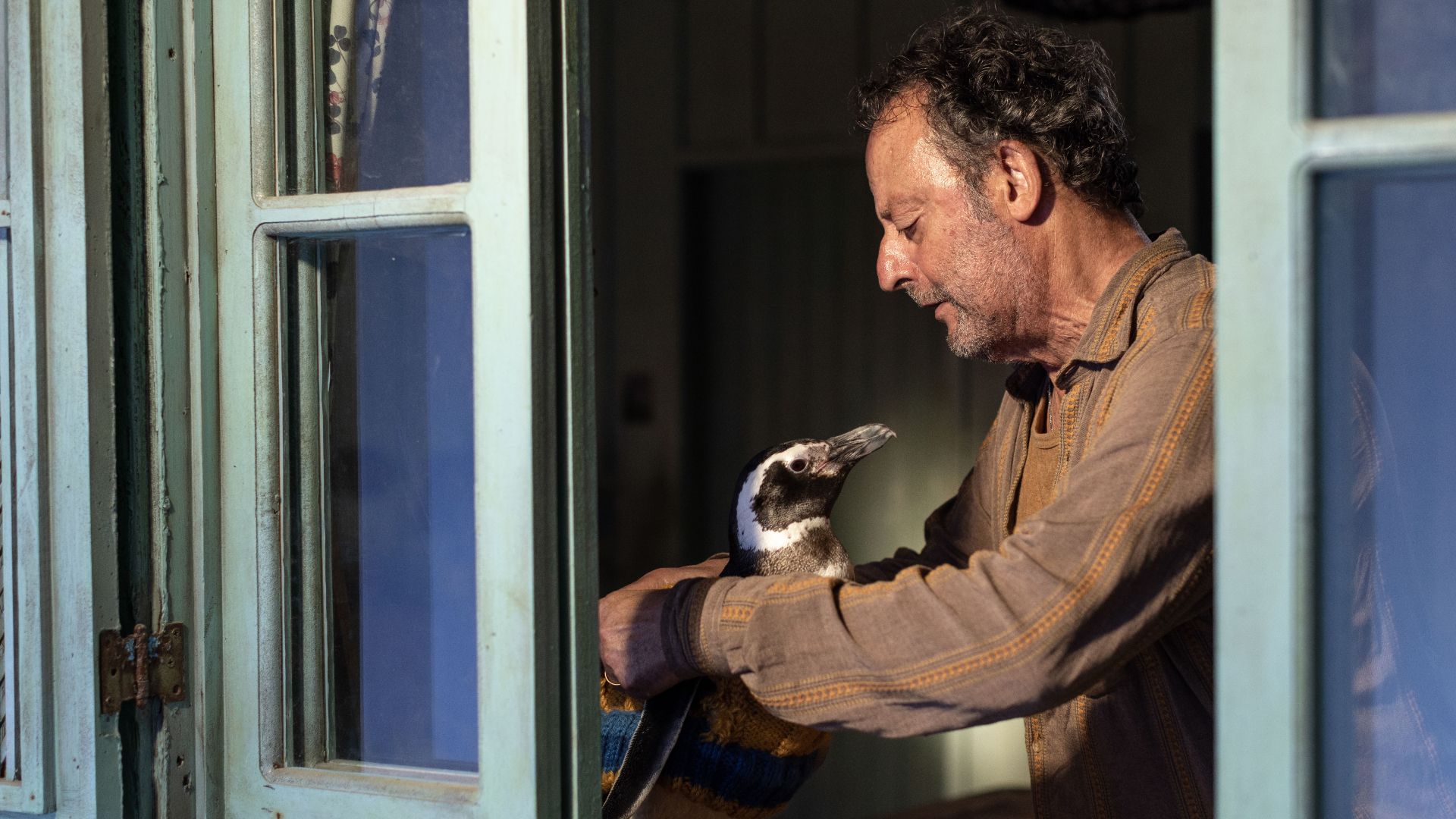 Jean Reno with his penguin in My Penguin Friend