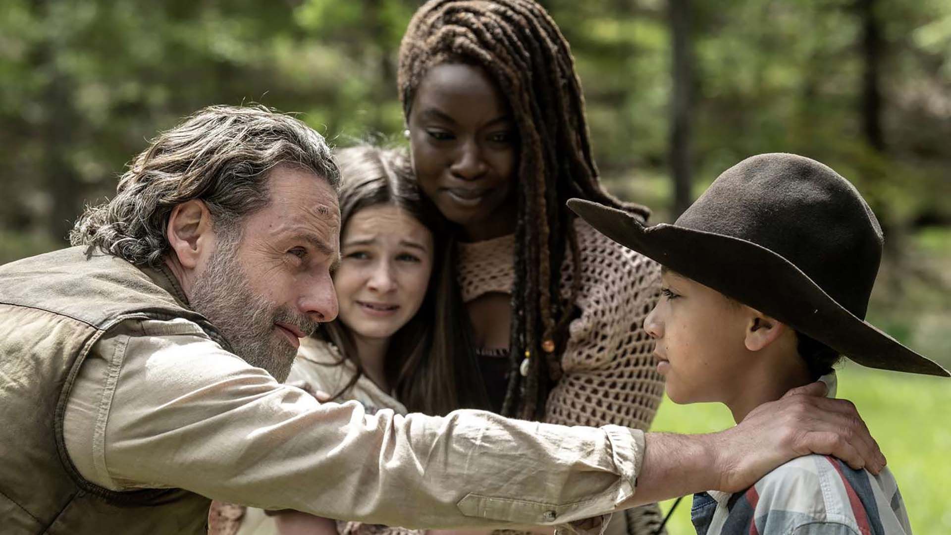 Rick with his hand on RJ's shoulder as Michonne and Judith look on in the finale of The Walking Dead: The Ones Who Live