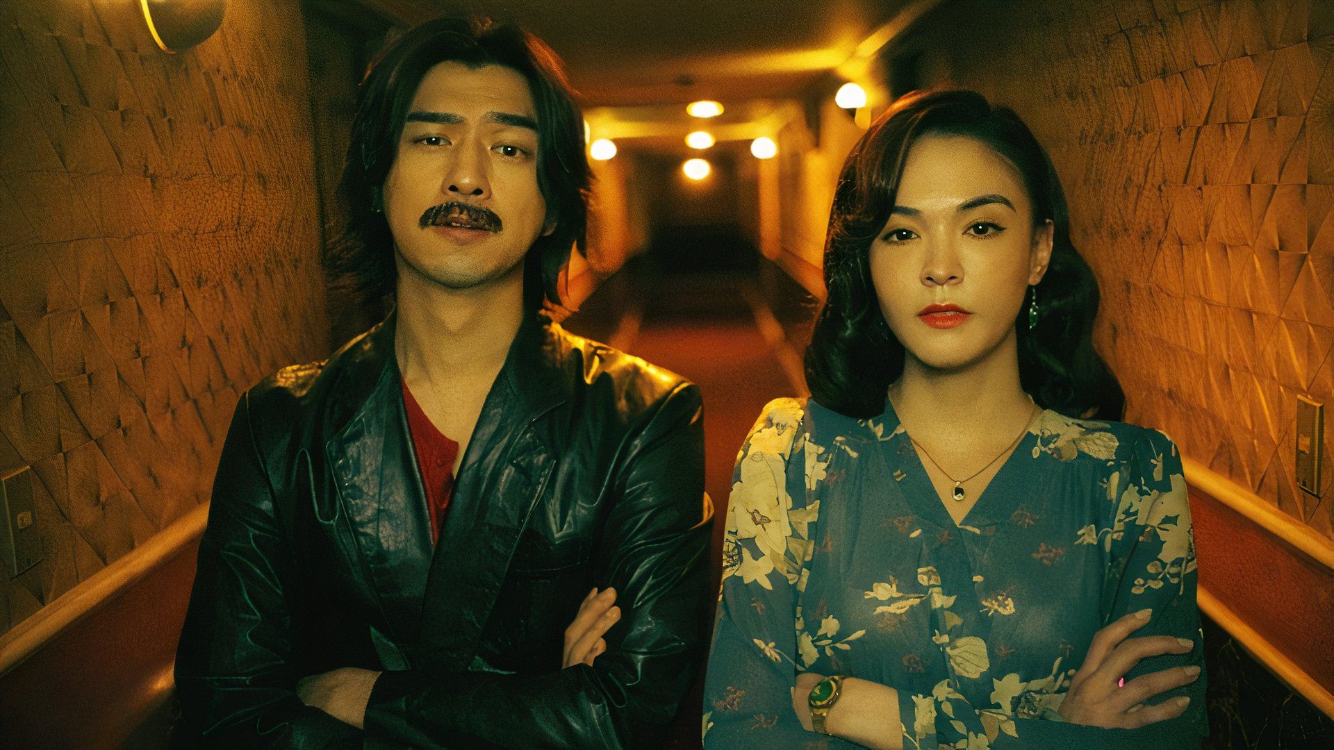 A man and woman fold their arms in John Hsu movie Dead Talents Society