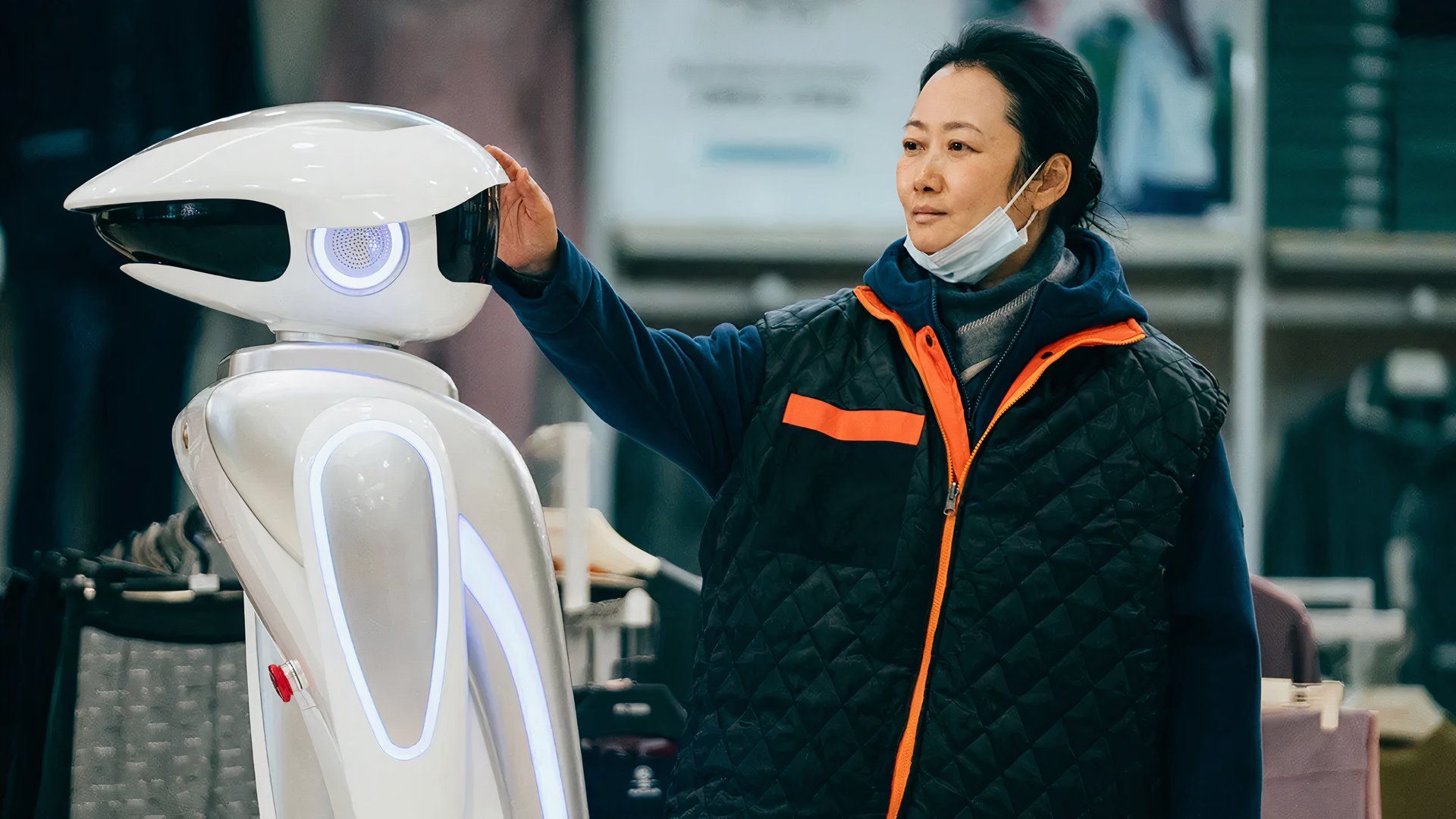 A woman with a robot in the movie Caught By the Tides