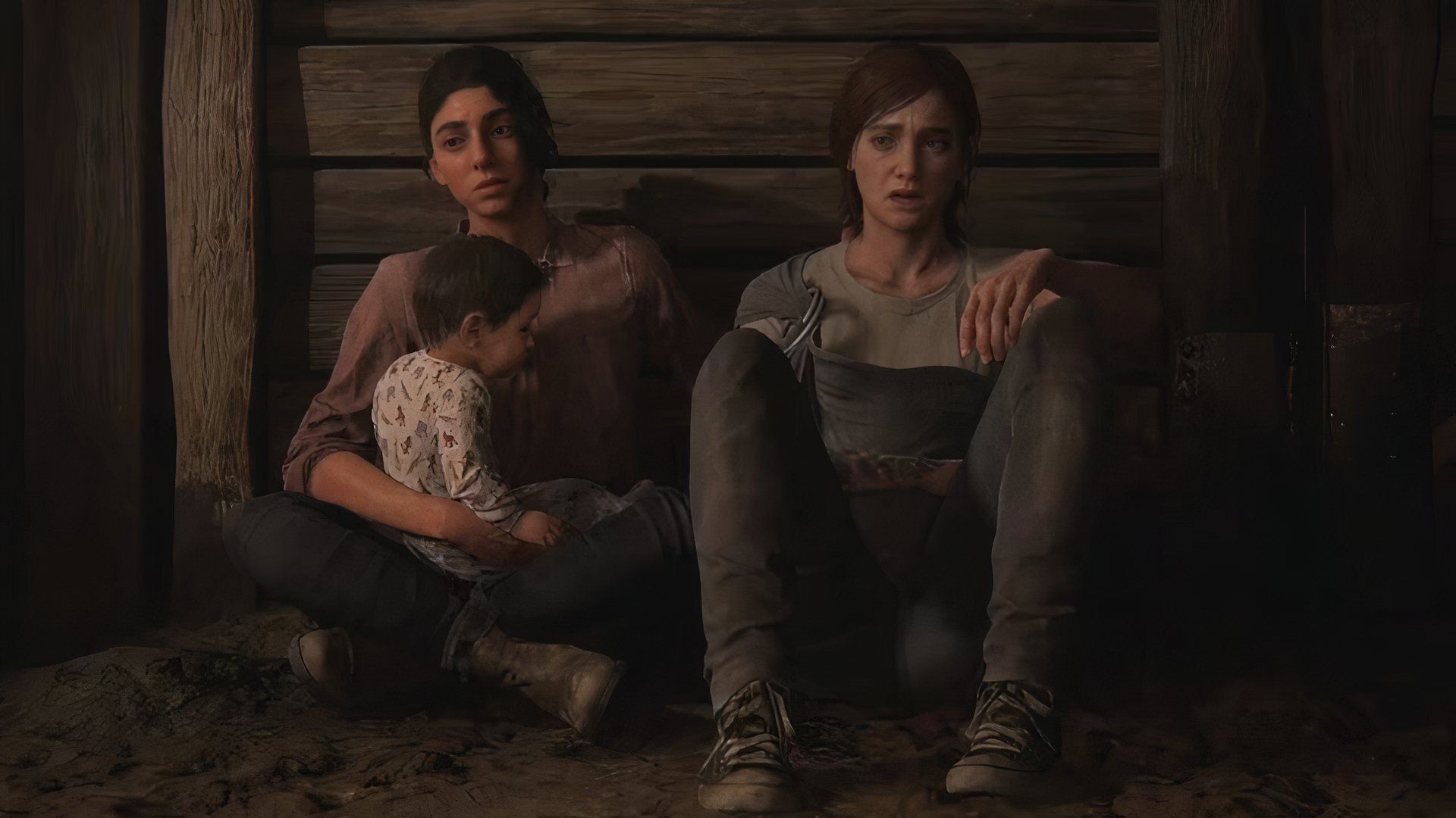 Dina, Ellie, and a baby sitting in a barn in The Last of Us Part 2