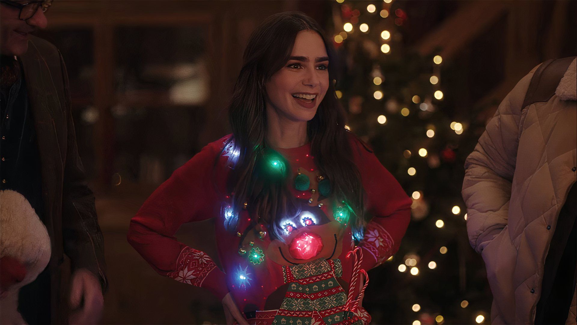 Lily Collins as Emily Cooper wearing a Christmas sweater in Emily in Paris.