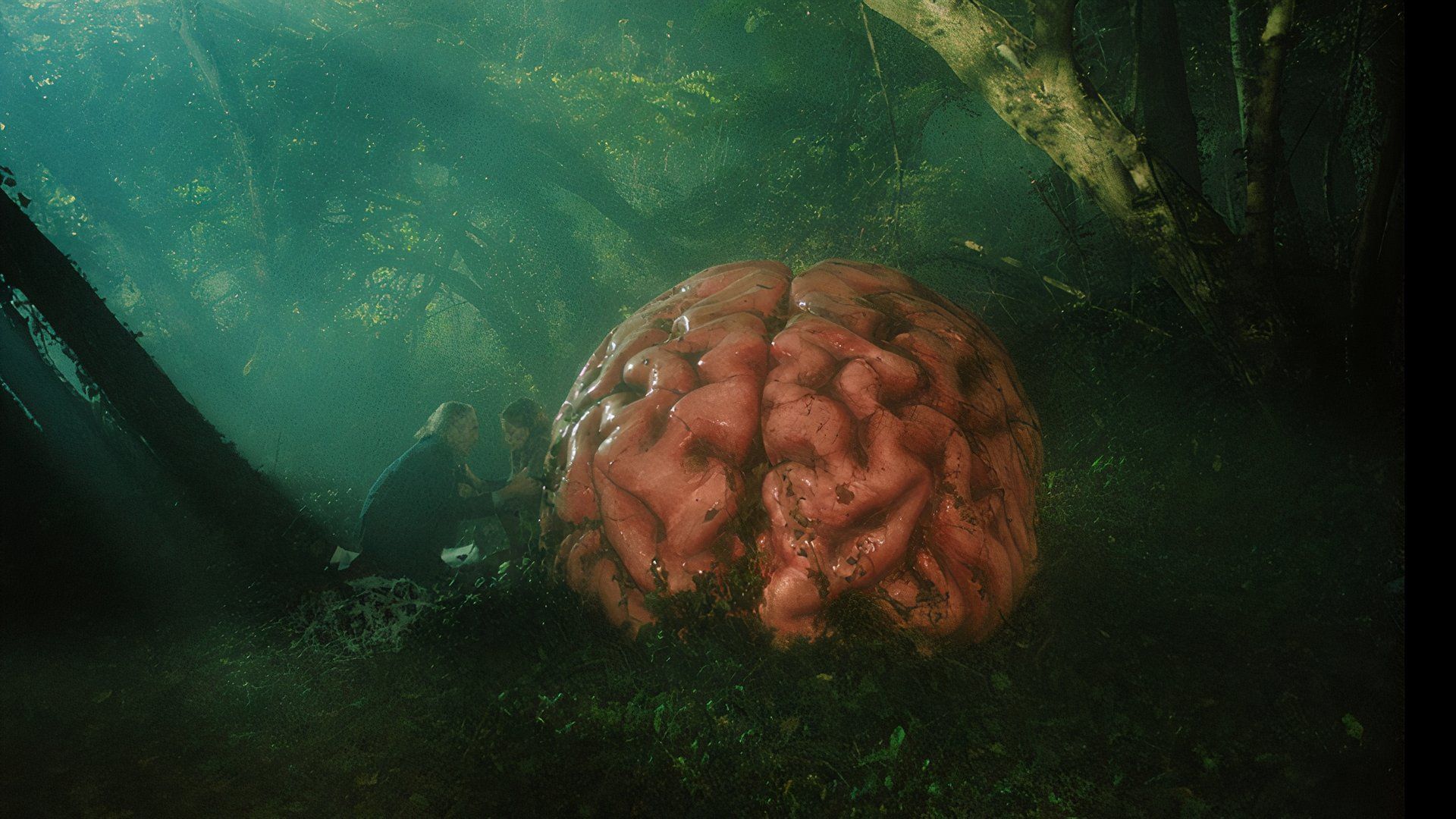 Hunched by a giant brain in the forest in the movie Rumours at TIFF 2024