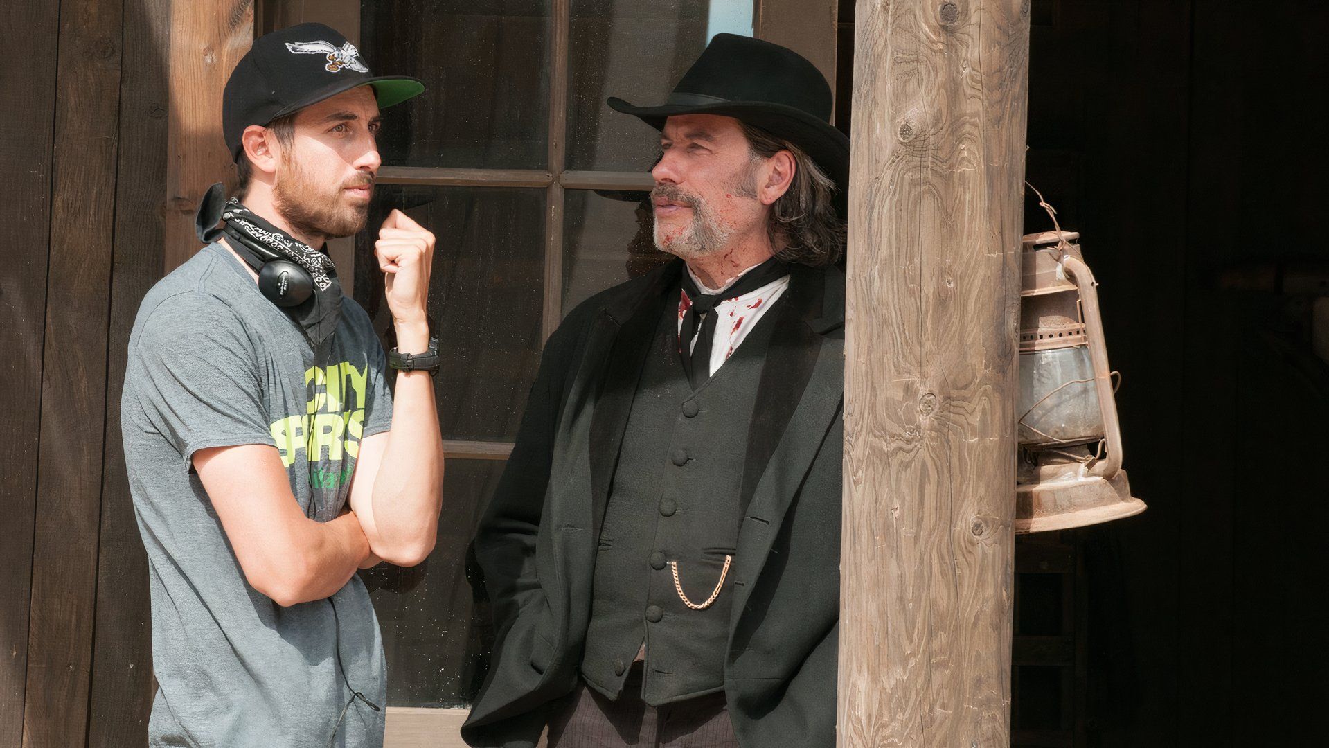 Ti West and John Travolta speak on the set of In a Valley of Violence