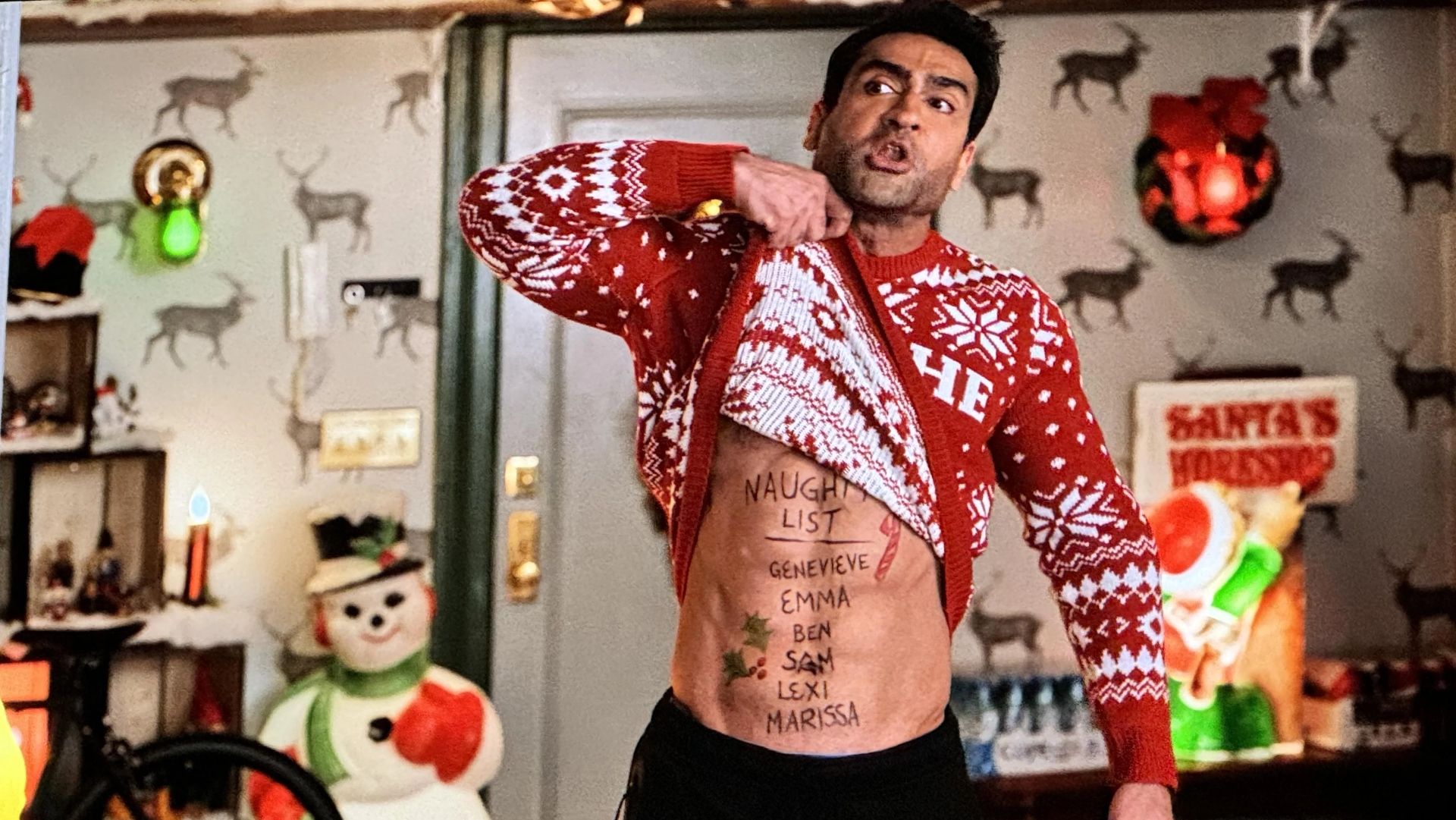 Kumail Nanjiani lifting up his Christmas sweater as Rudy in Only Murders in the Building