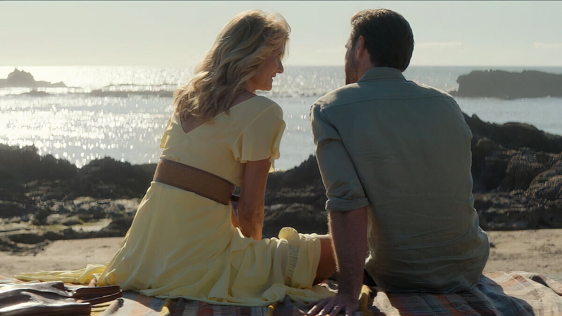 Laura Dern and Liam Hemsworth in Lonely Planet at the beach