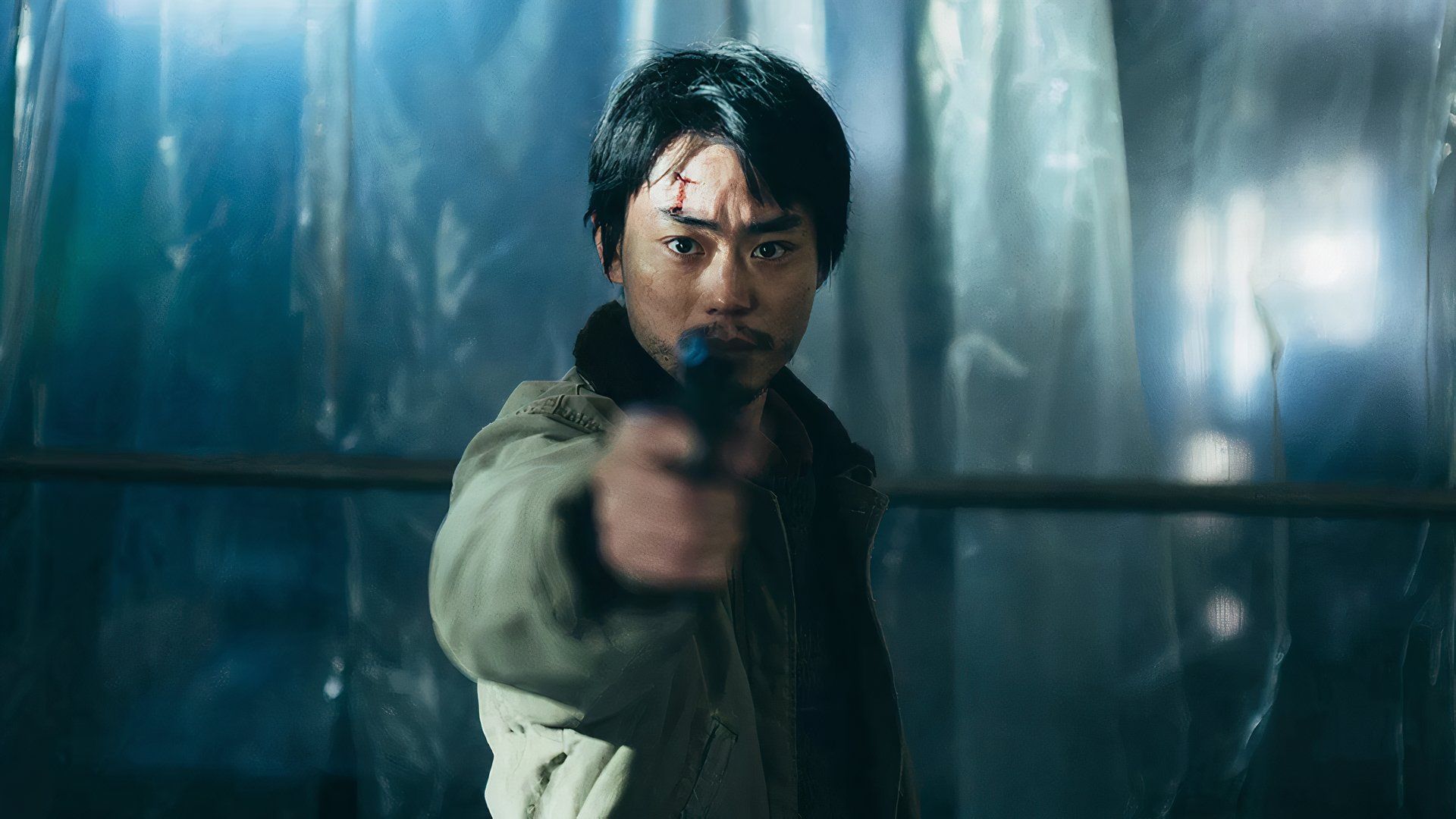 Masaki Suda points a gun in the Kiyoshi Kurosawa film Cloud