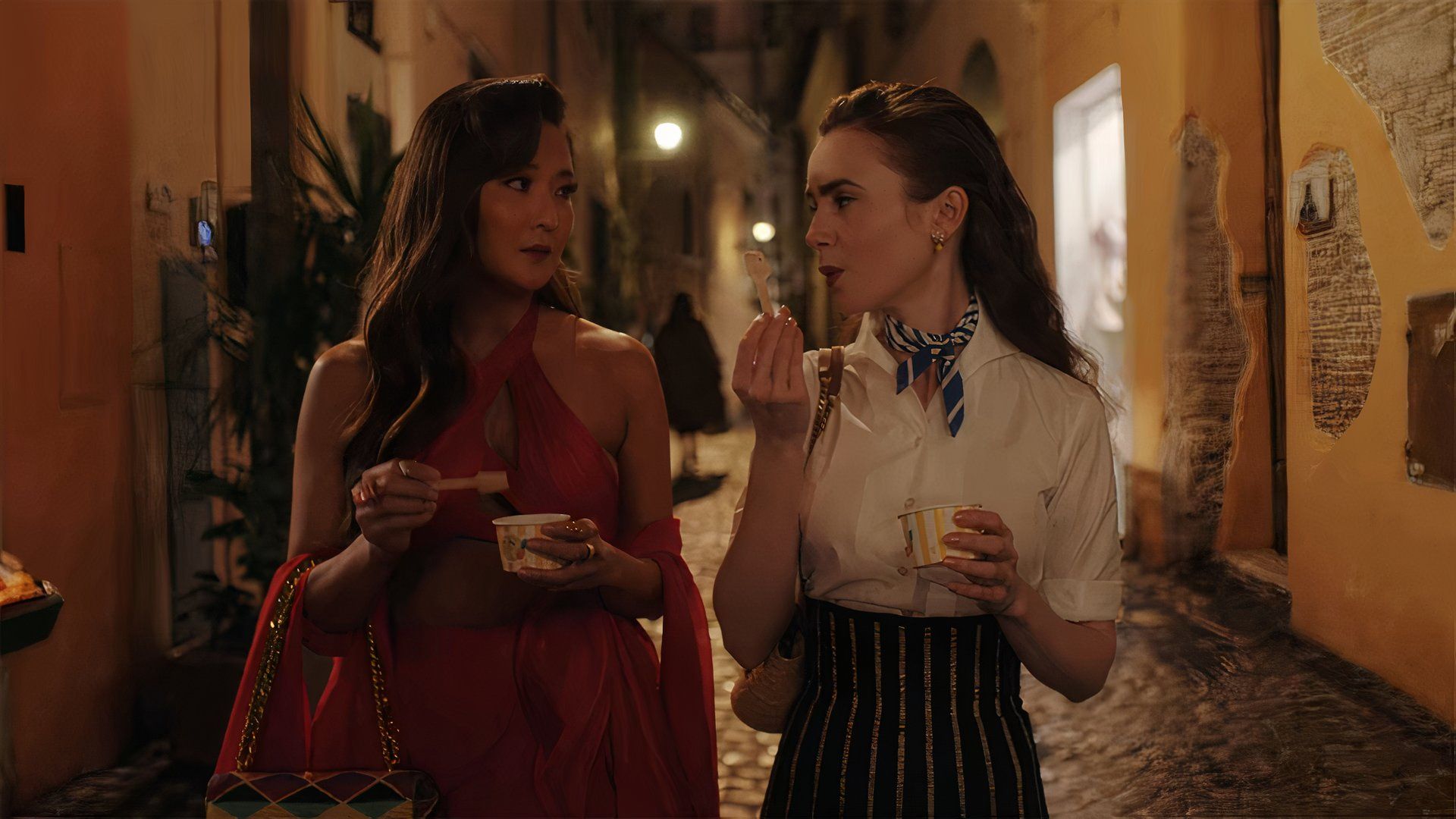 Emily (Lily Collins) and Mindy (Ashley Park) in Emily in Paris.