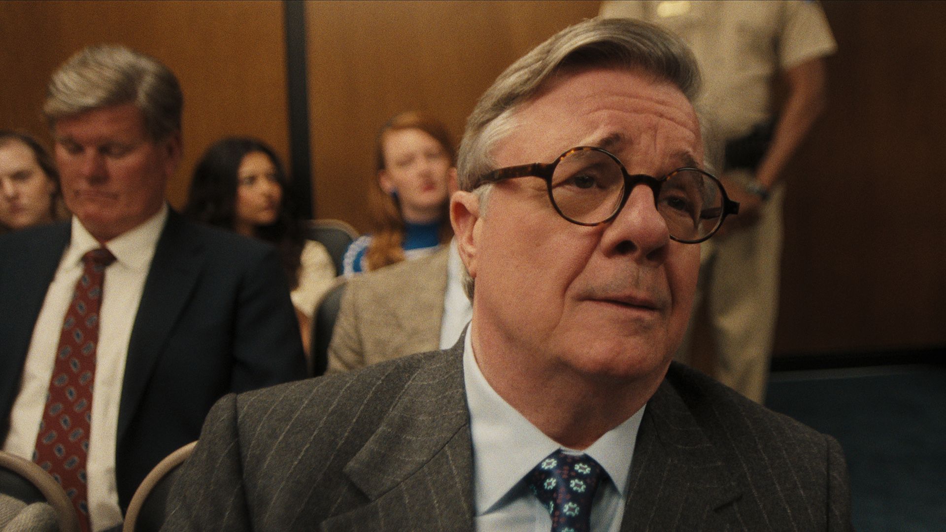 Dominick Dunne in Monsters looking empathetic while watching the trial.