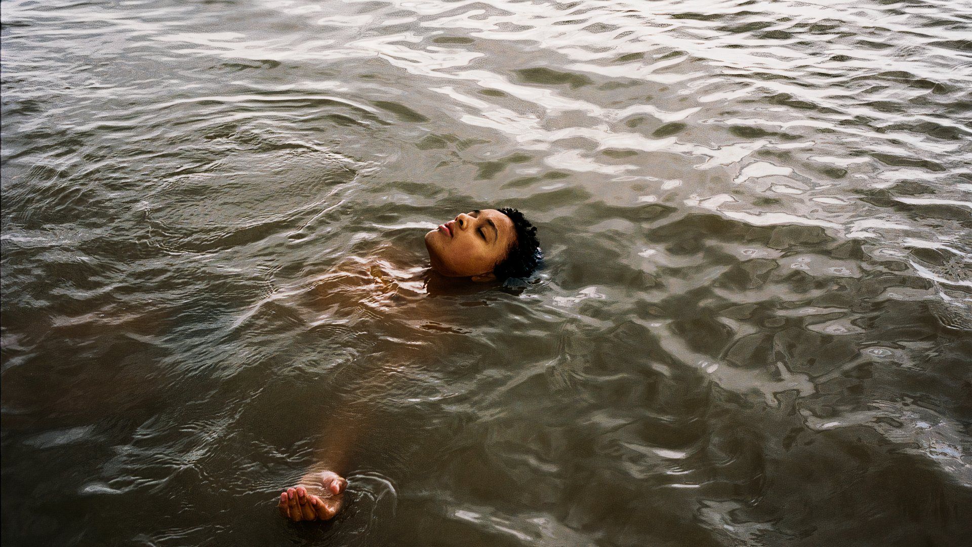 Nykiya Adams as Bailey in the water in the 2024 movie Bird with Barry Keoghan