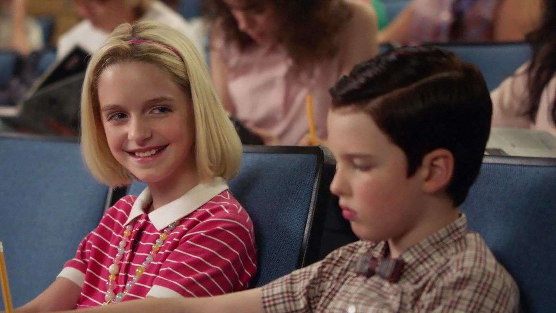 Paige smiling at Sheldon in a lecture on Young Sheldon.