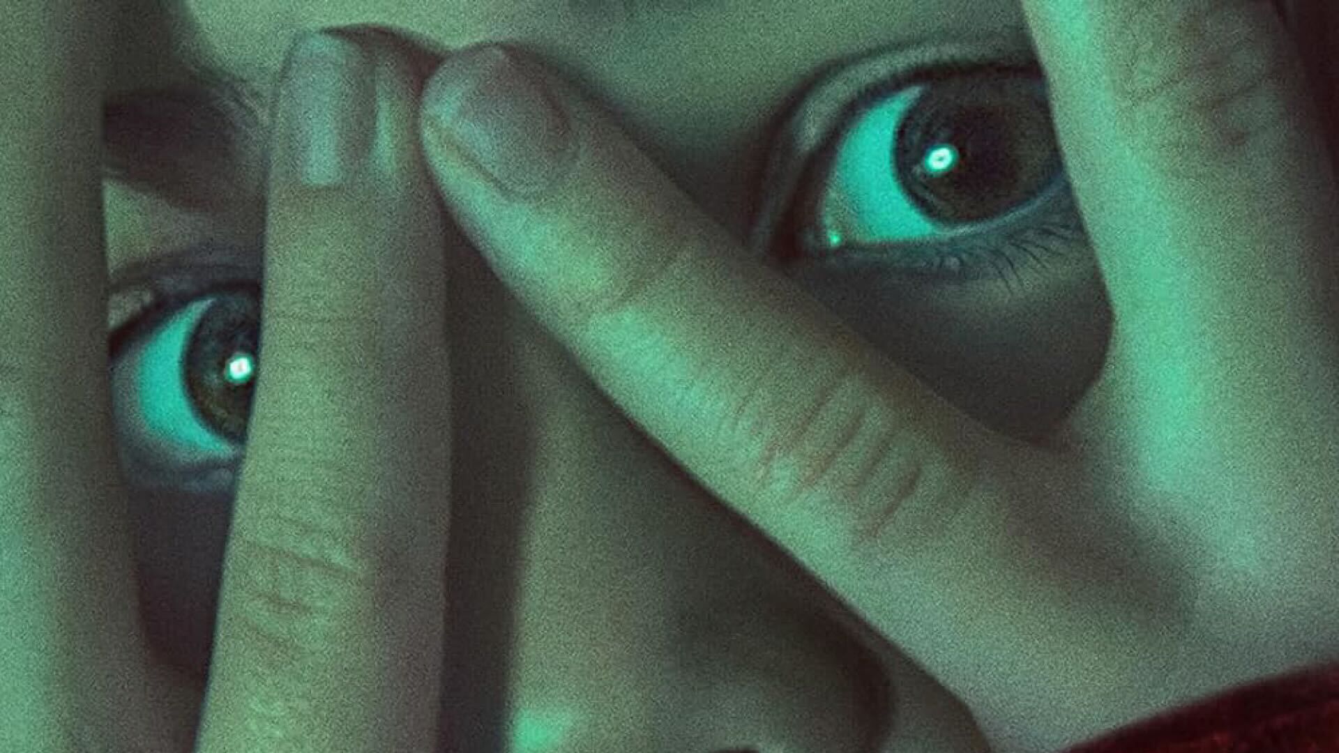 Girl Looks through fingers in Blumhouse Wolf Man Poster