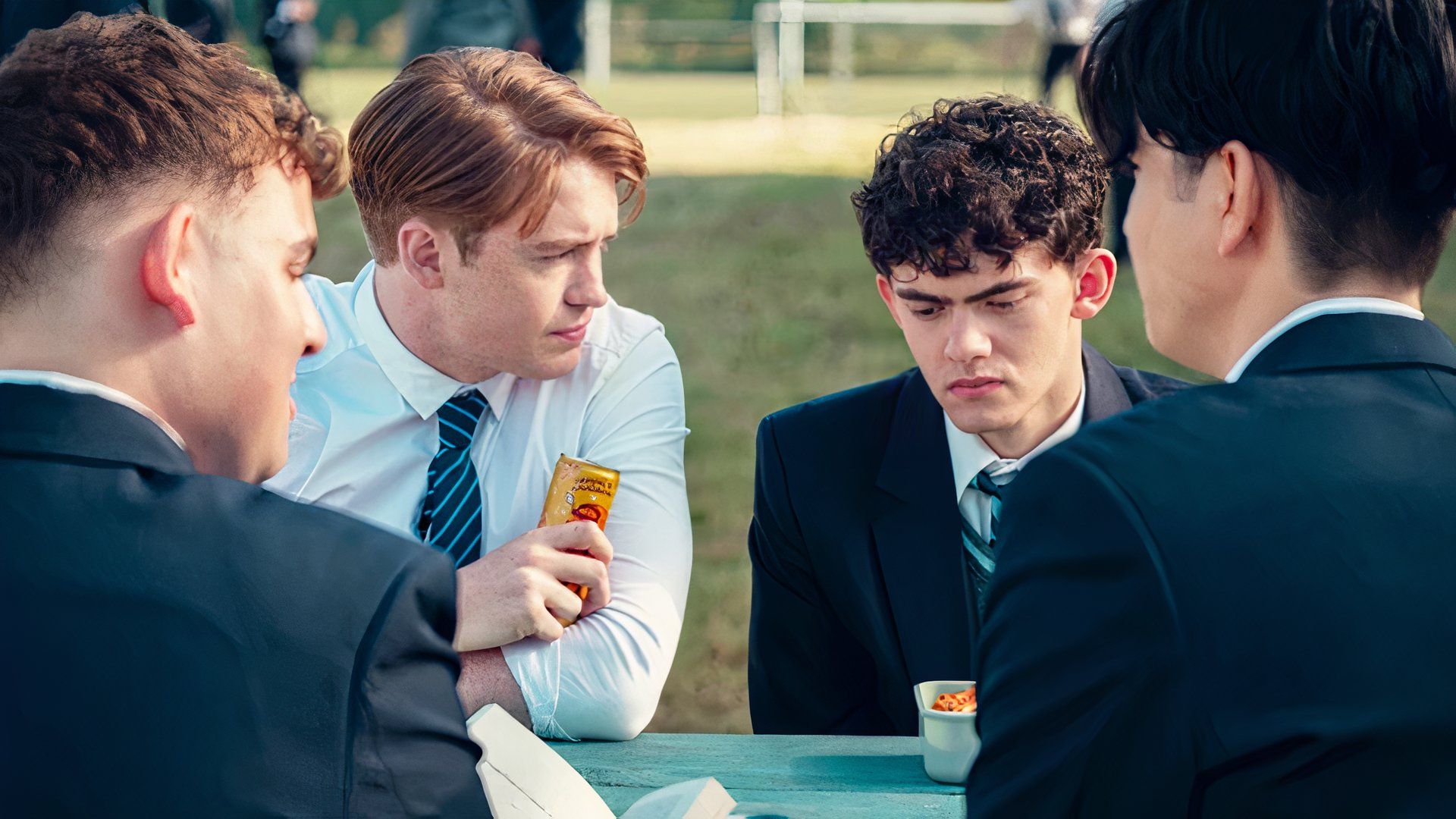 Nick and Charlie sit at a bench in Heartstopper